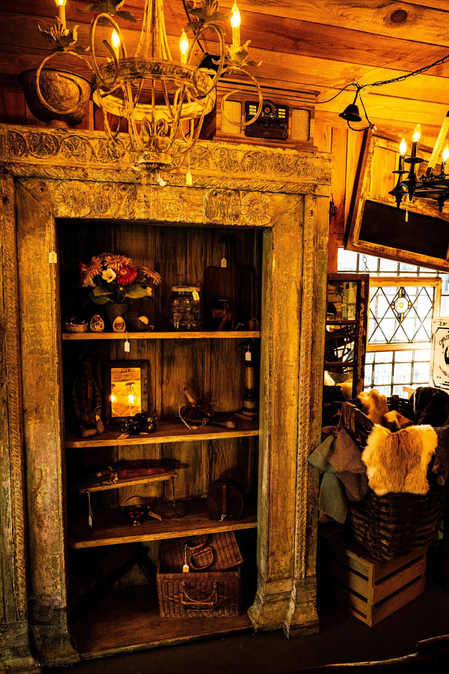 Dimly lit antique store shelves displaying vintage collectibles and decorative items.