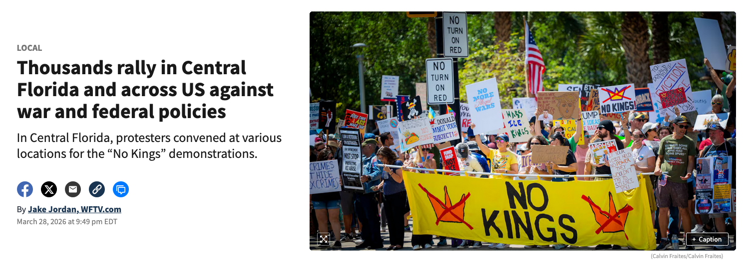 Protesters hold colorful signs and banners during a peace demonstration against war and military spending.