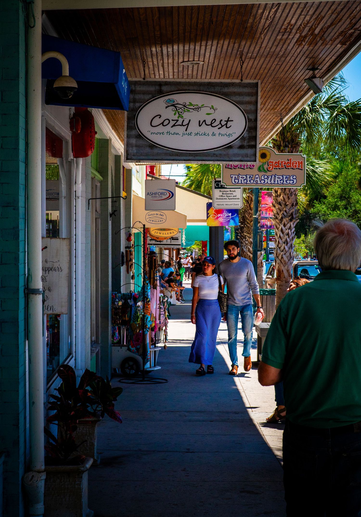 Cozy West storefront with covered sidewalk along a busy shopping district.