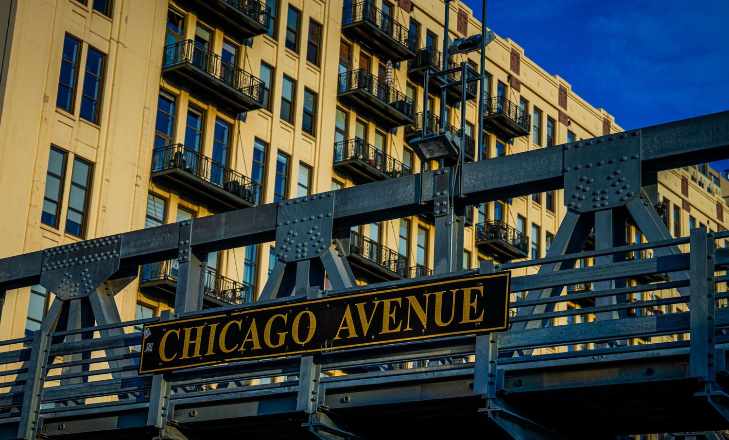 Long residential building with Chicago Avenue signage and multiple balconies along its facade.