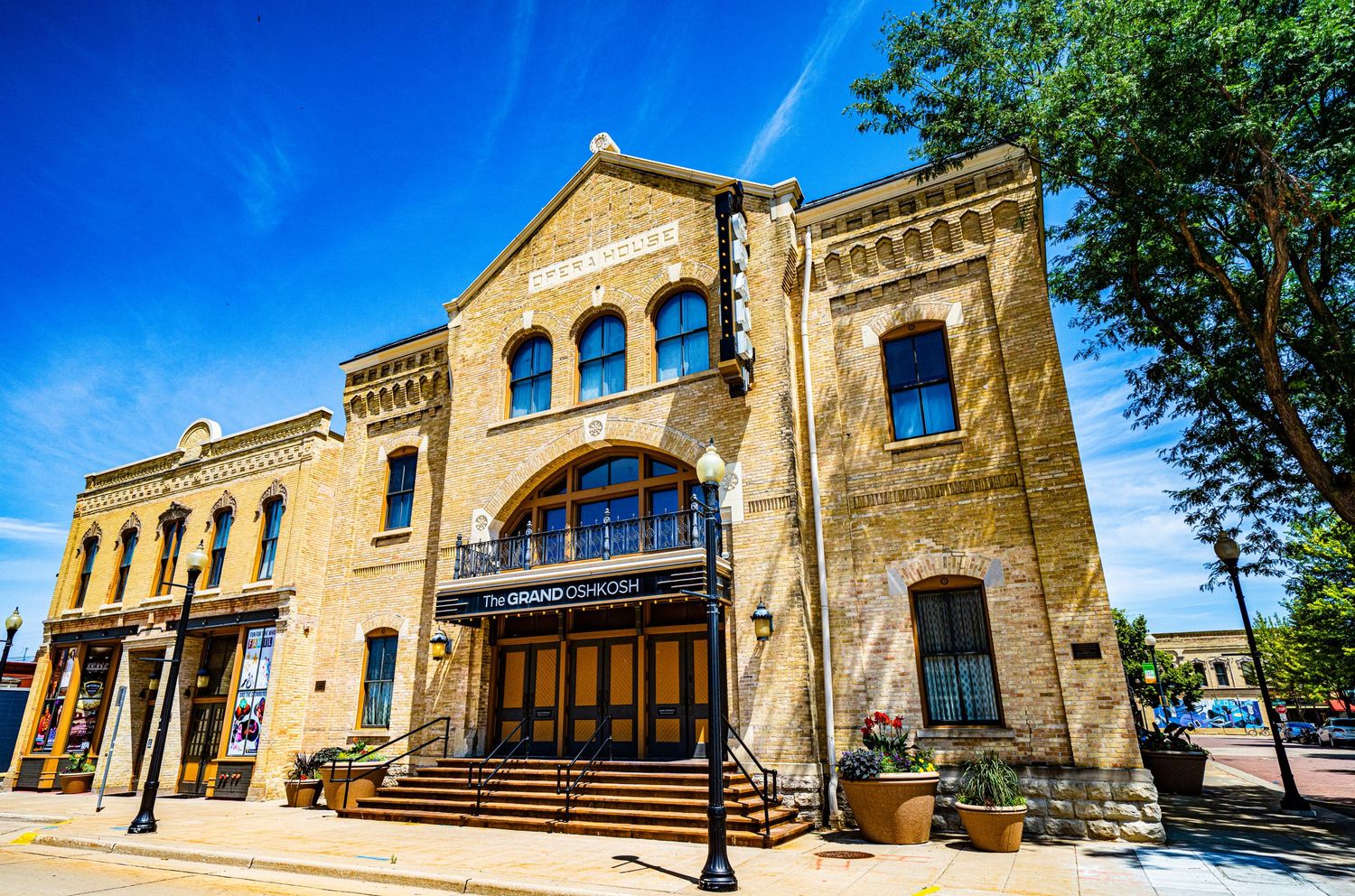 Historic stone building with arched windows and ornate architectural details in warm sunlight.