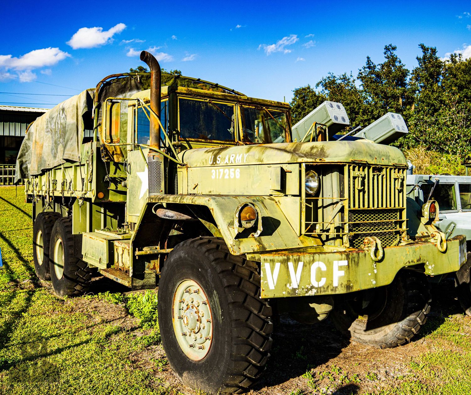 Row of military Humvees and tactical vehicles displayed on gravel at an outdoor museum.