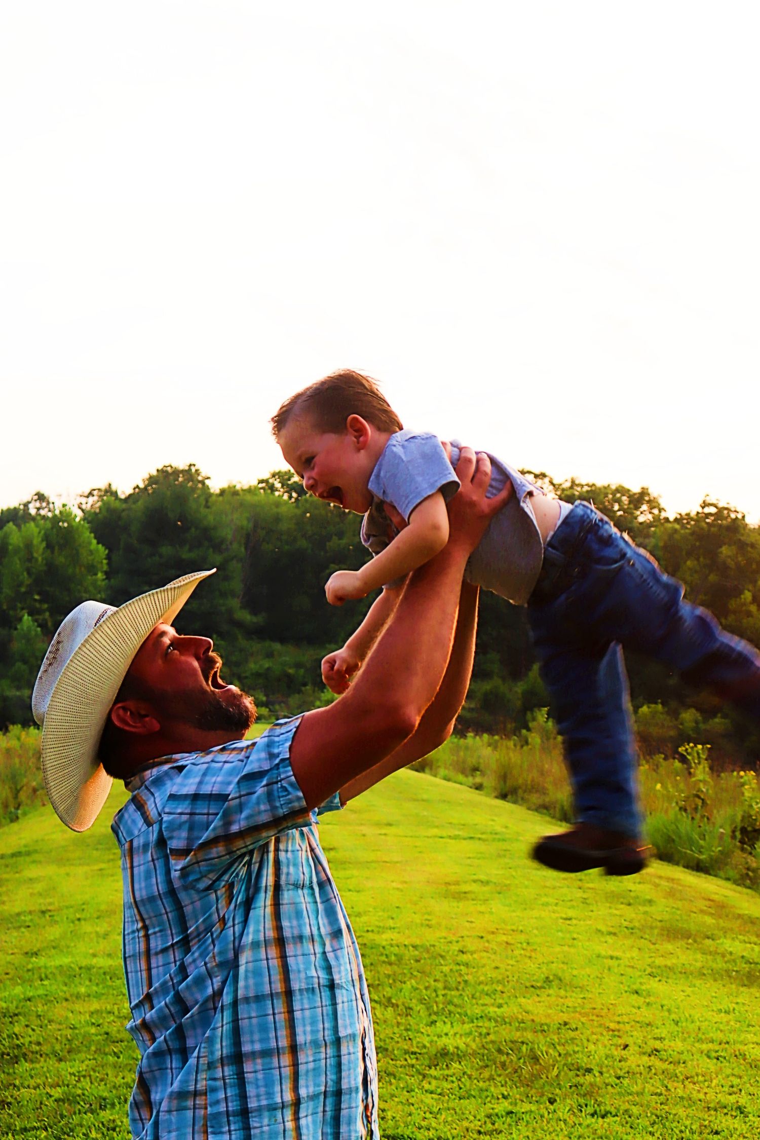 Dad and son playing in the beautful sun on a nice summer evening