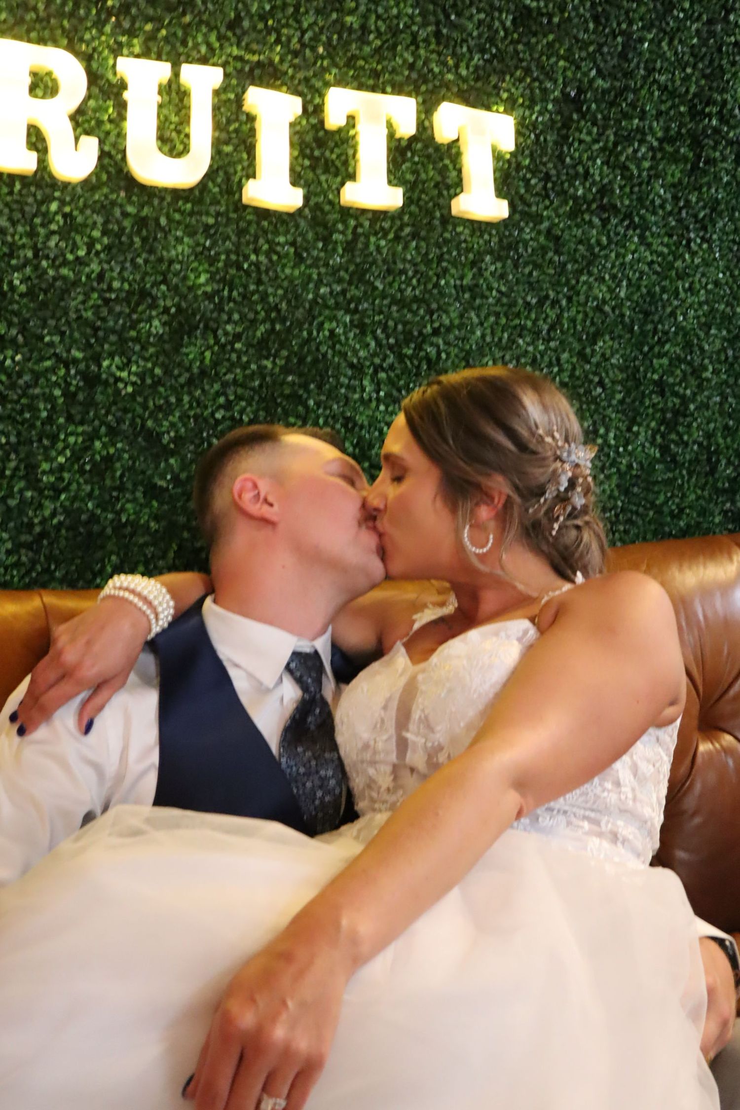 Here is a picture of the bride and groom sitting on the couch for that classic pose.
