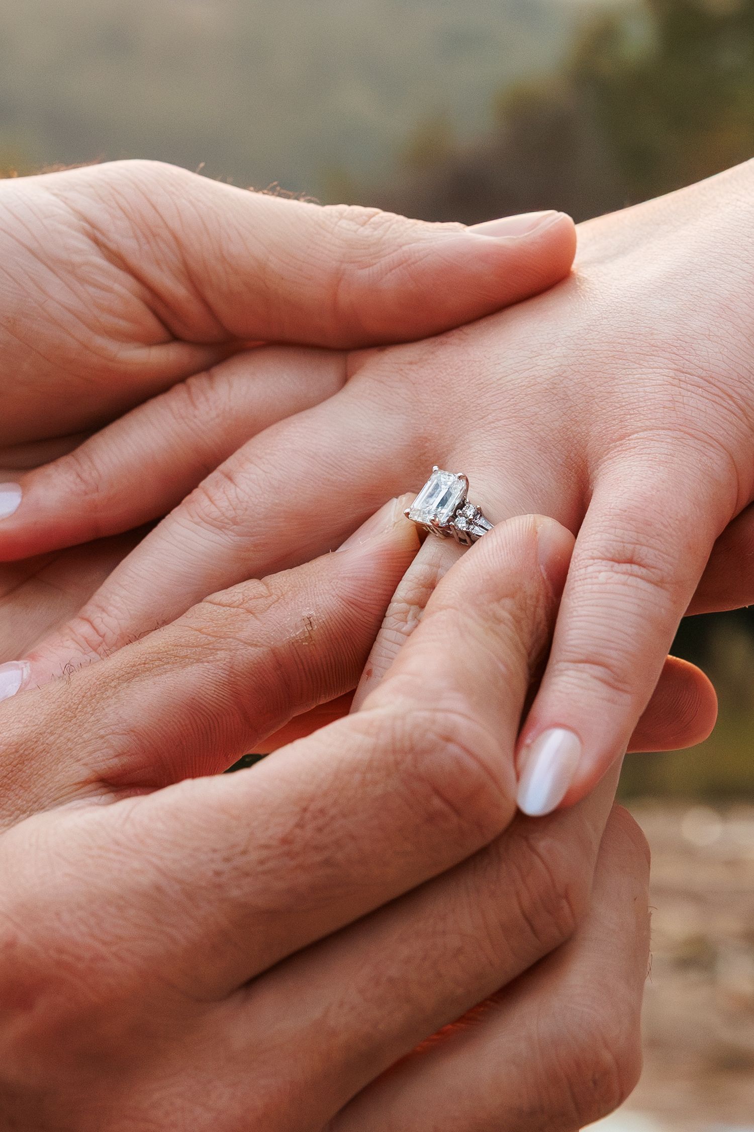 Close-up series of hands showing engagement ring being placed on finger in romantic proposal sequence.
