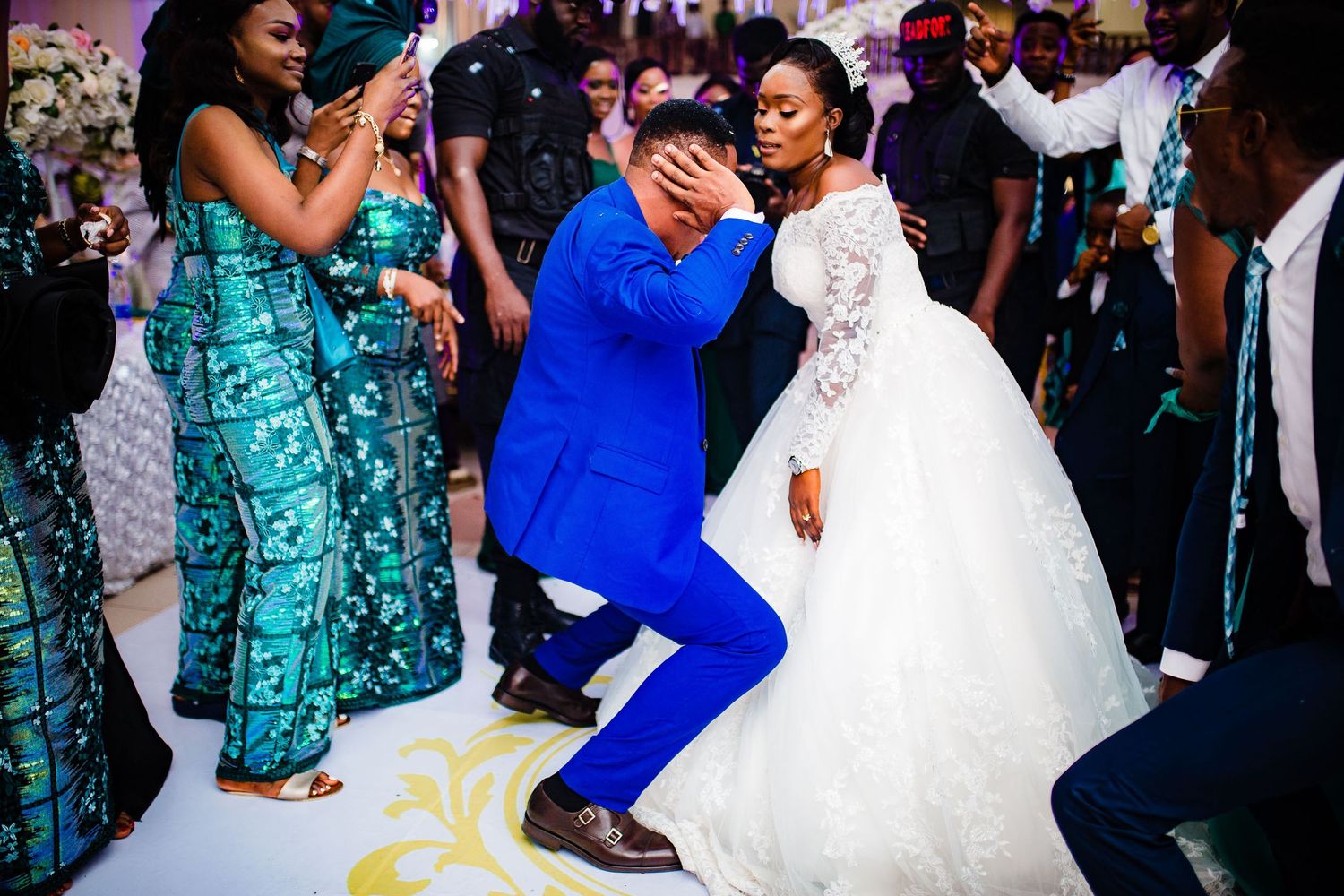 Wedding celebration with dancers on the dance floor as guests enjoy a lively moment in elegant attire.