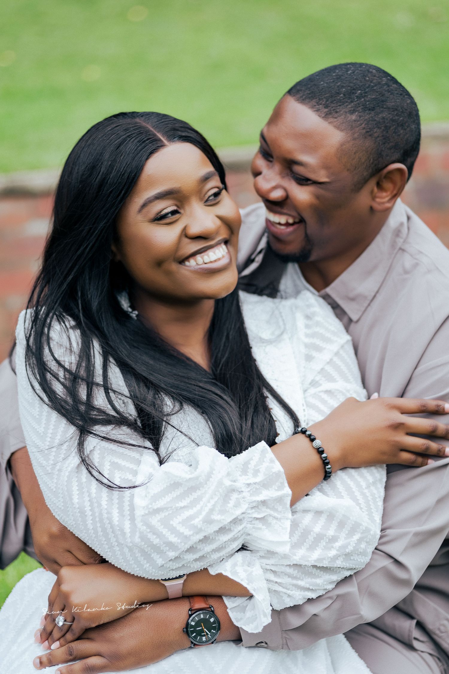 Candid moment of couple laughing during outdoor portrait session.