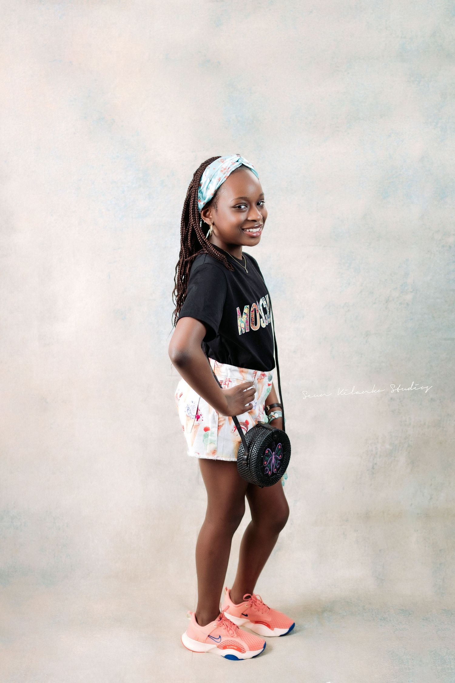 Casual summer style with Moschino t-shirt, white shorts and coral sneakers.
