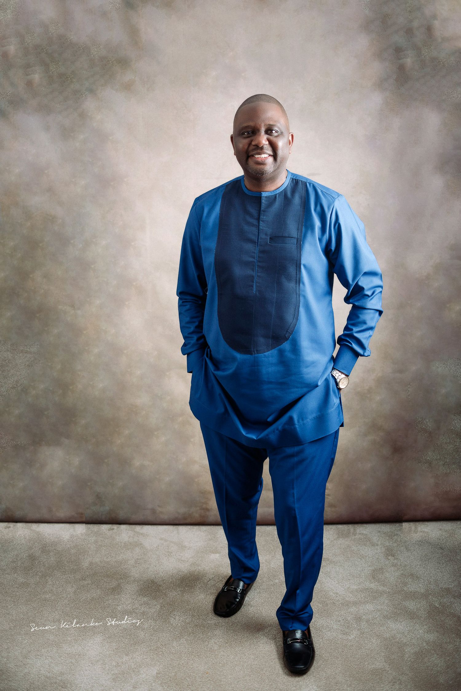Stylish modern blue traditional African suit ensemble with matching pants.