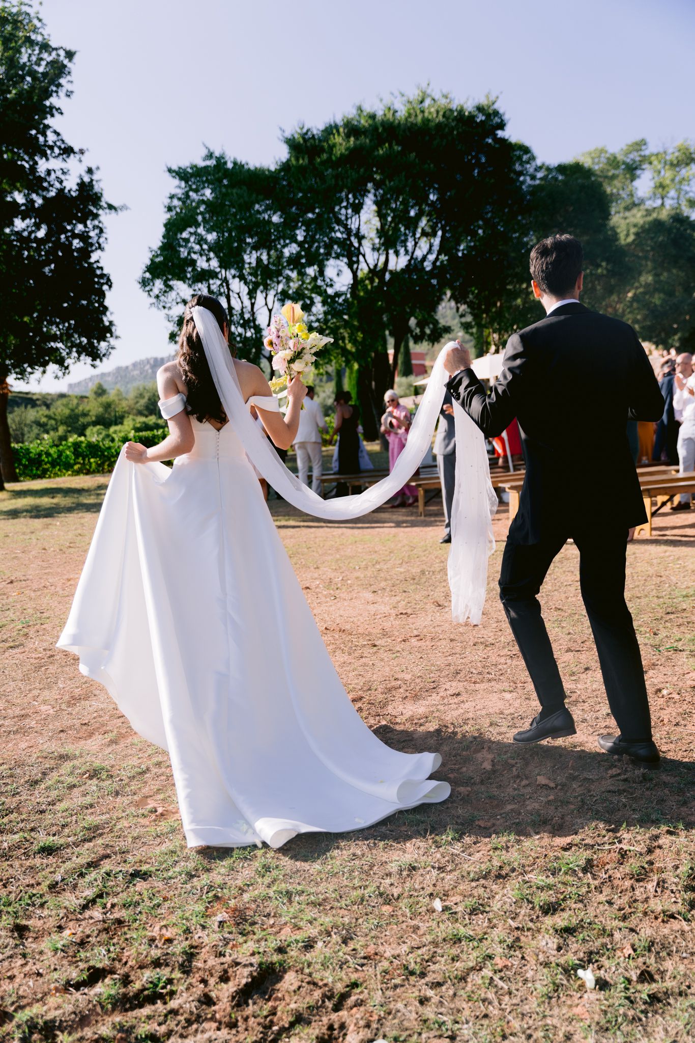 A sequence of wedding photos showing a couple dancing and twirling in an outdoor setting with sunlit trees in the background.