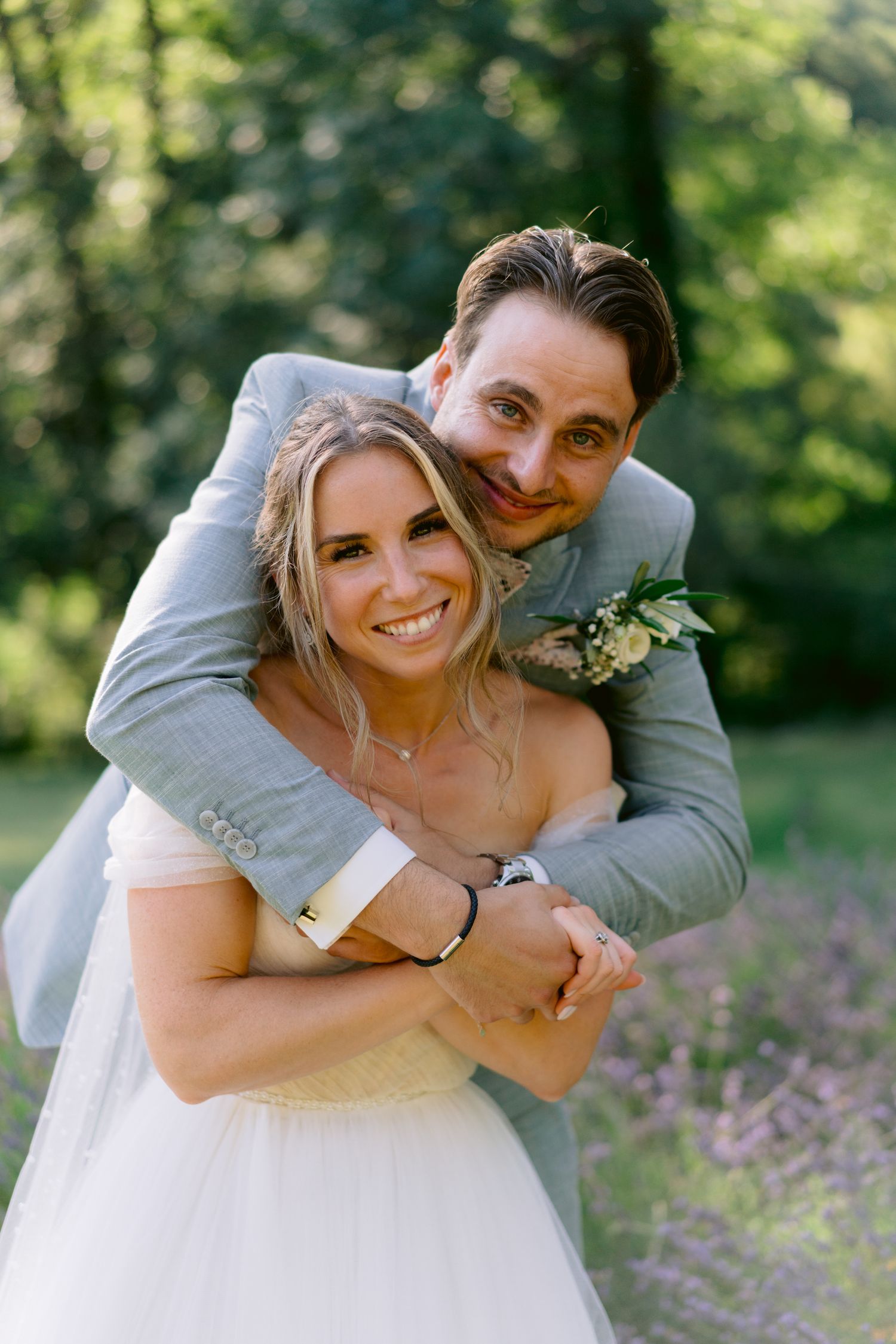 A joyful wedding moment captured in a sunny garden setting.