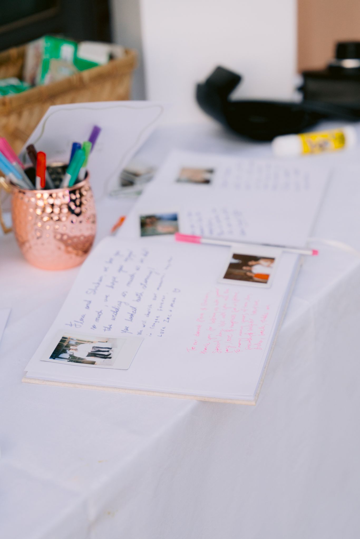 Handwritten wedding vows and notes spread across white table with rose gold decorative accessories.