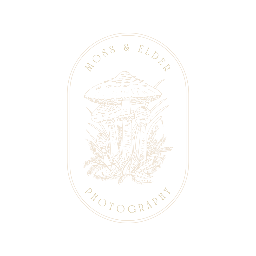 Artistic logo design featuring a mushroom and floral elements in a white oval badge shape against black background.