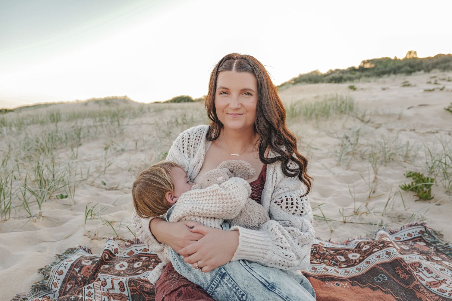 Newcastle Family Photographer capturing mother breastfeeding toddler at the beach