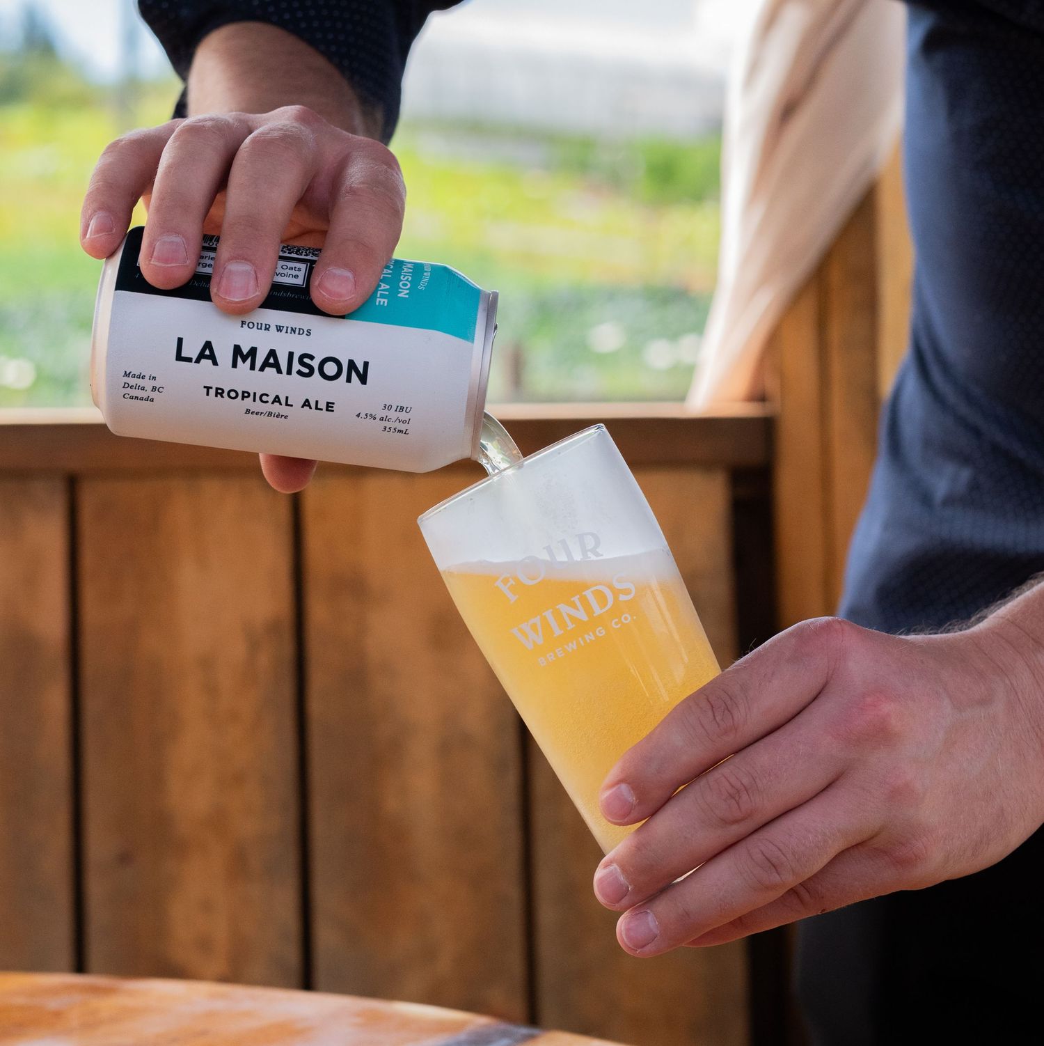 man pouring a beer into a glass