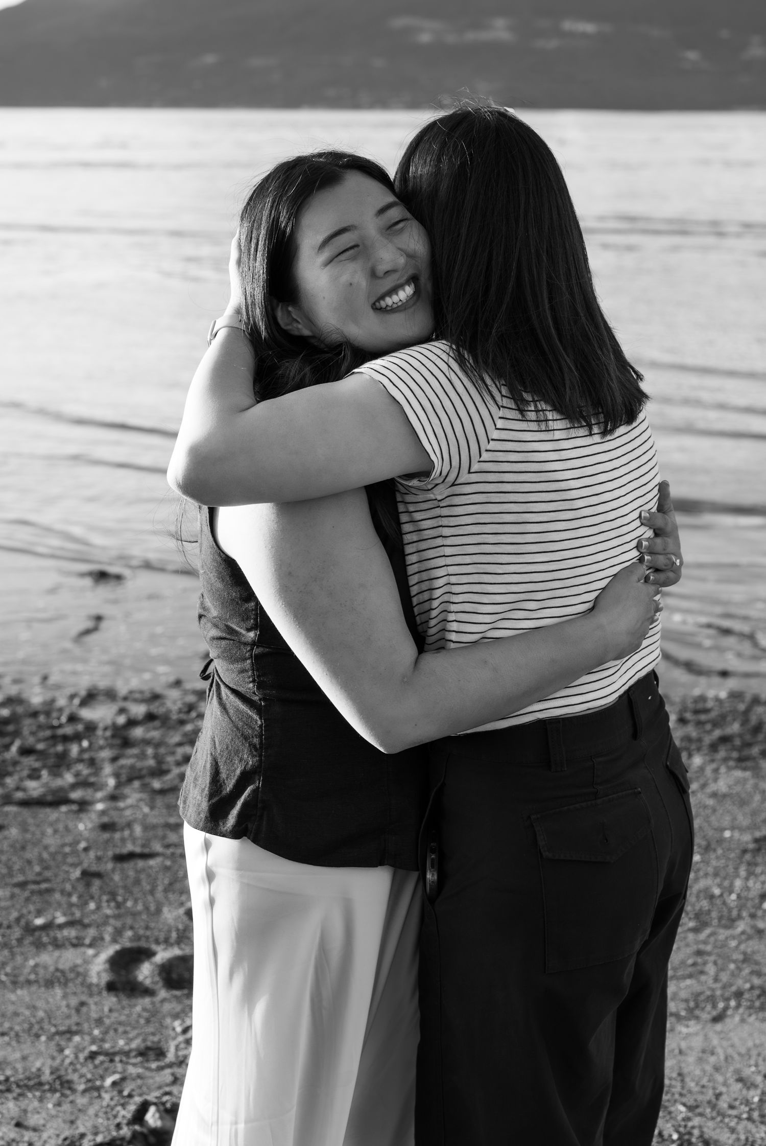 black and white photo of woman hugging sister