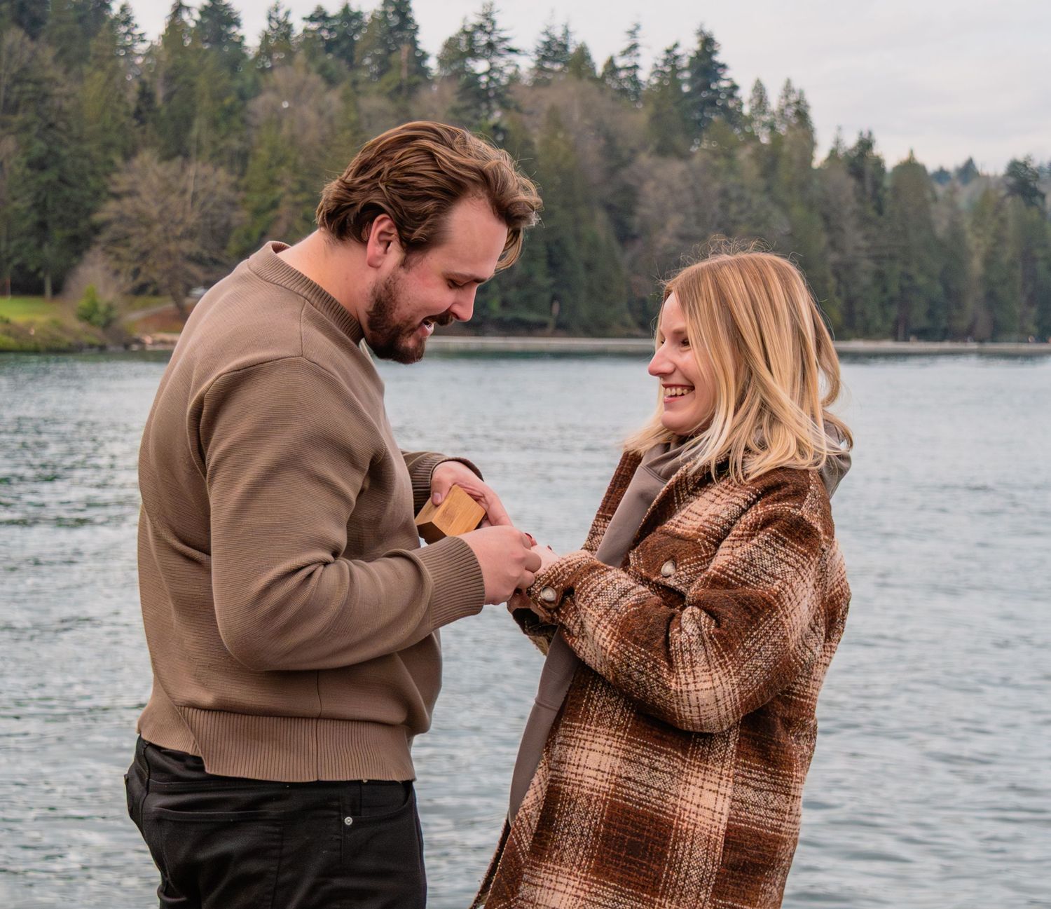 man and woman happily look at the ring
