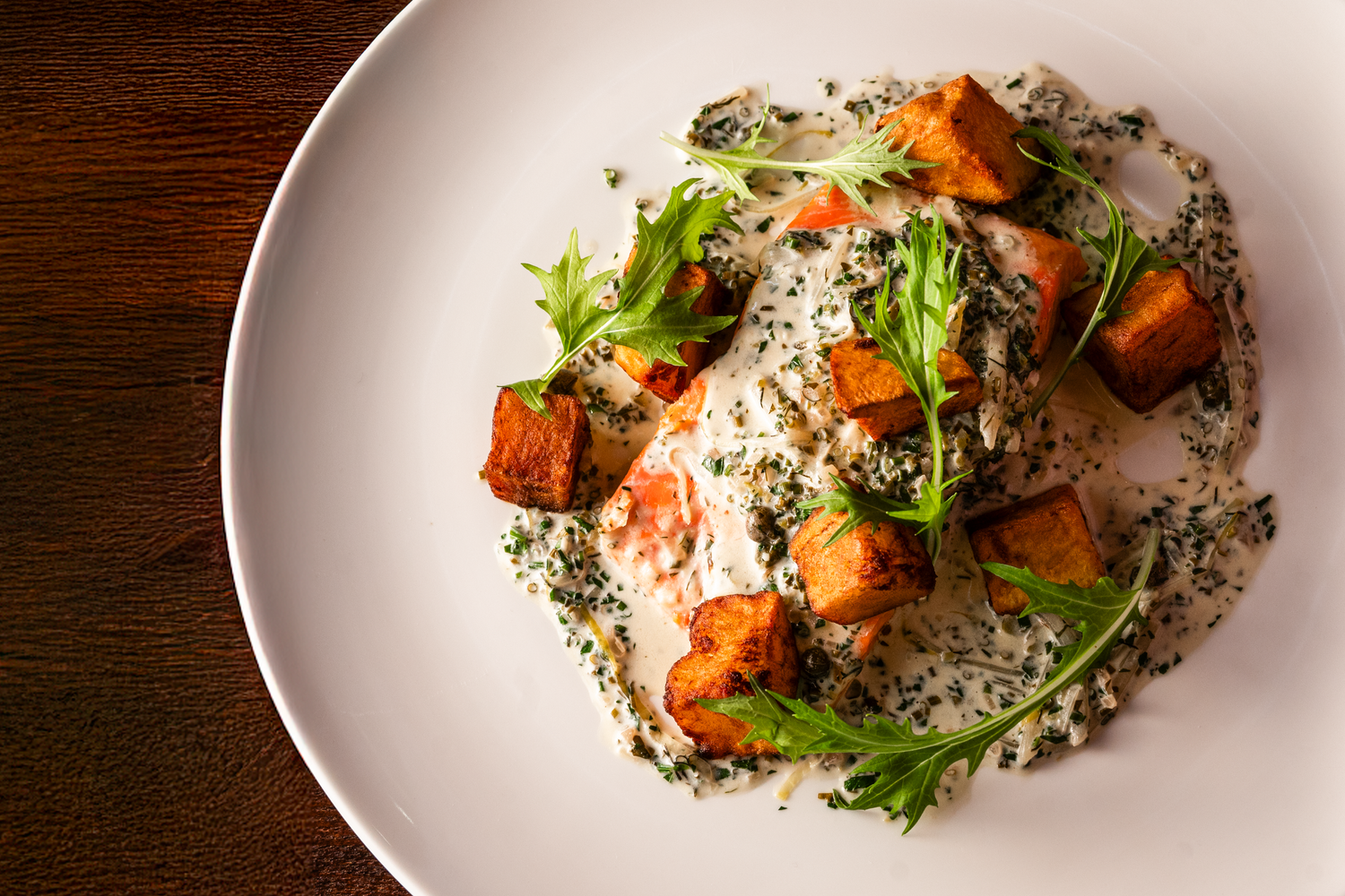 An overhead shot of a beautifully plated dish featuring grilled salmon.
