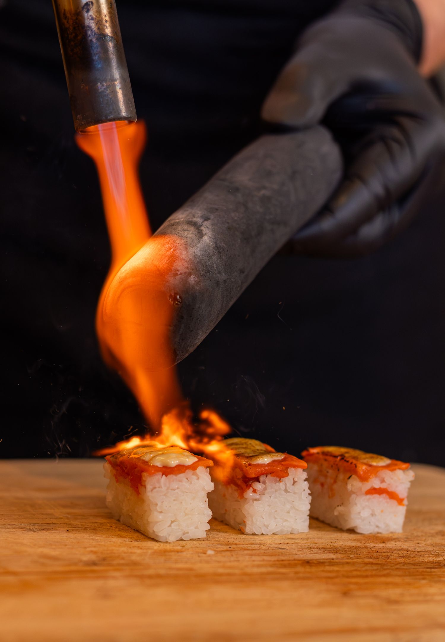 piece of sushi being flamed