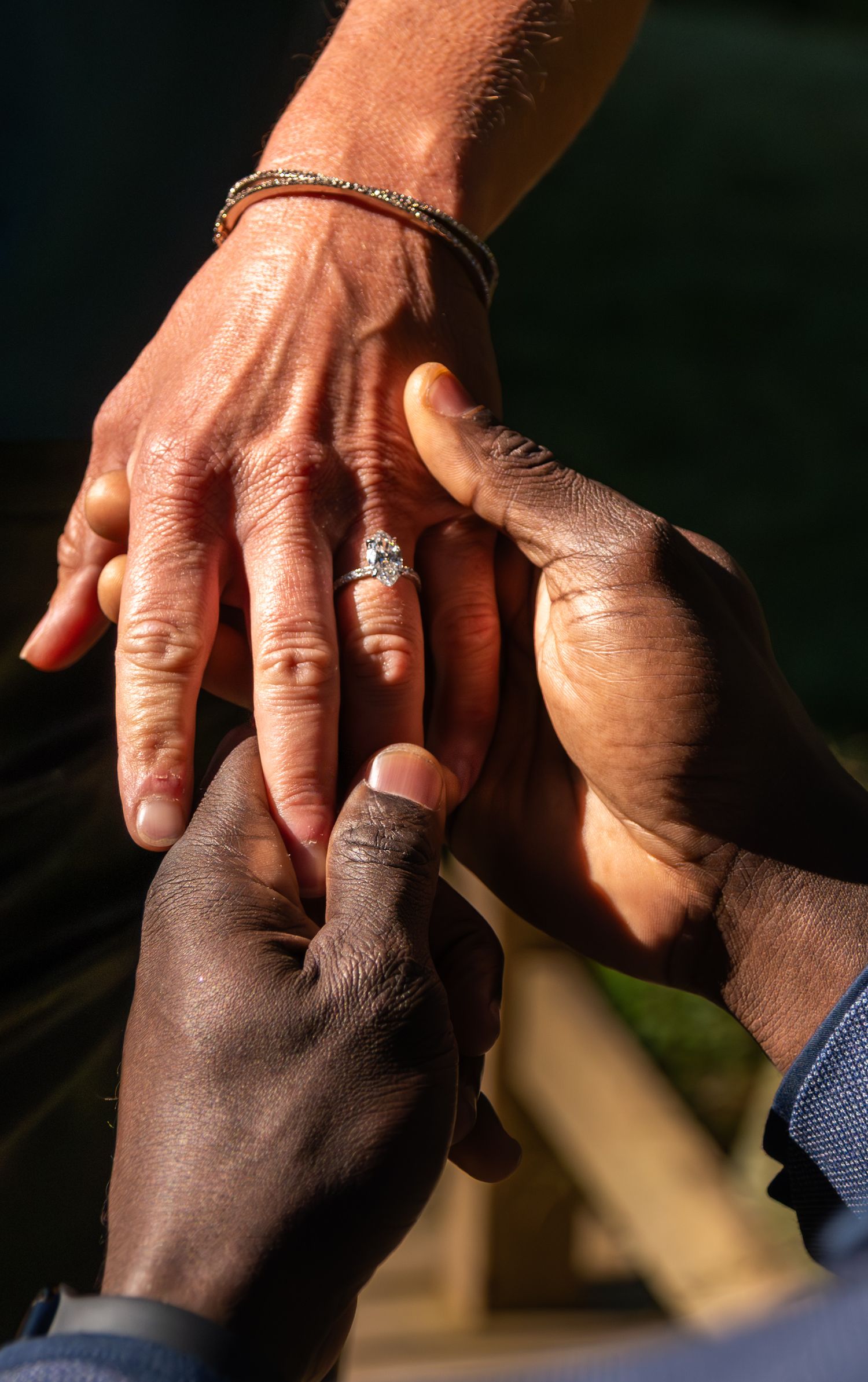 man holding womans hands showing off her ring