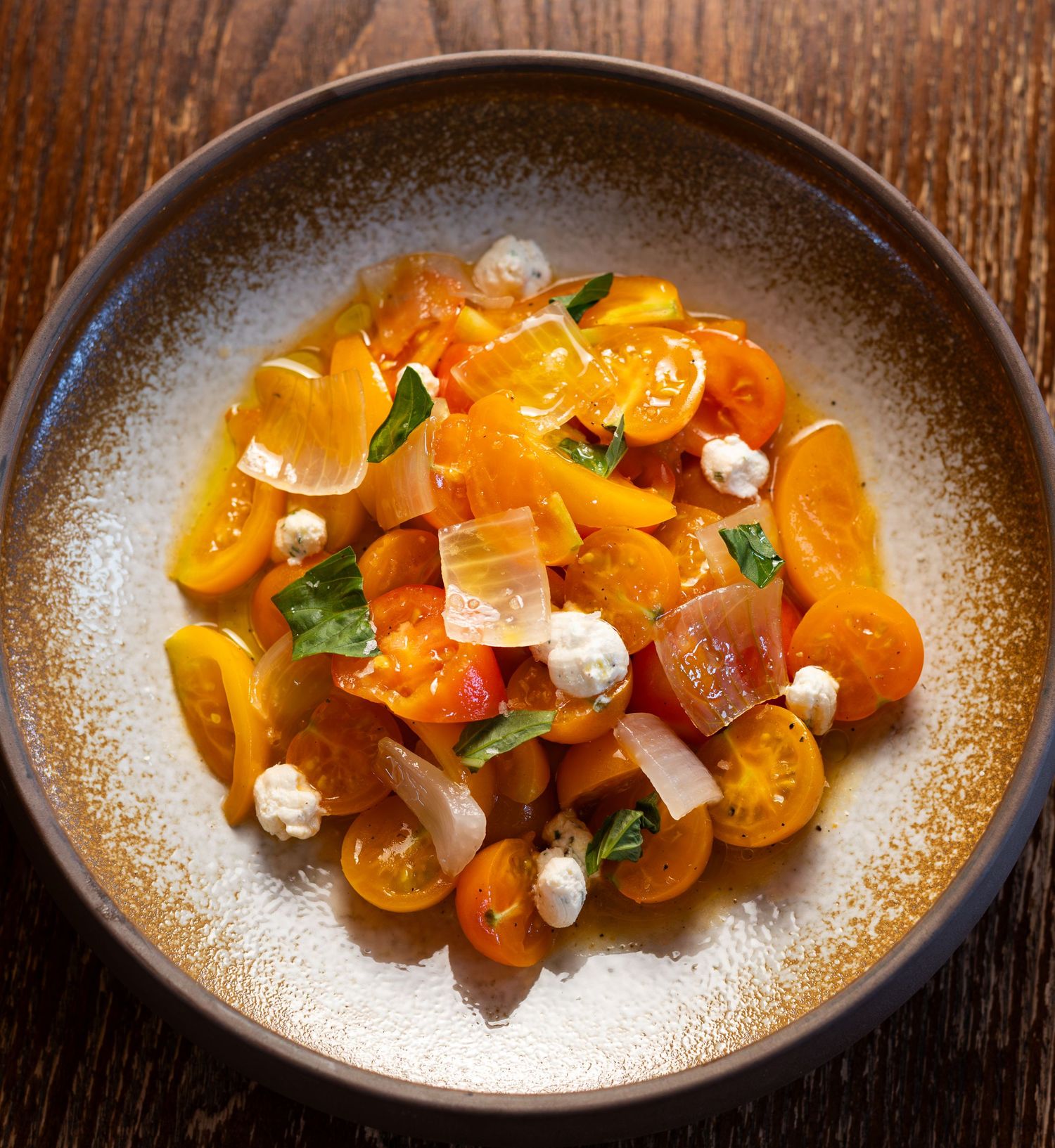 colourful photo of a dish with yellow tomatoes