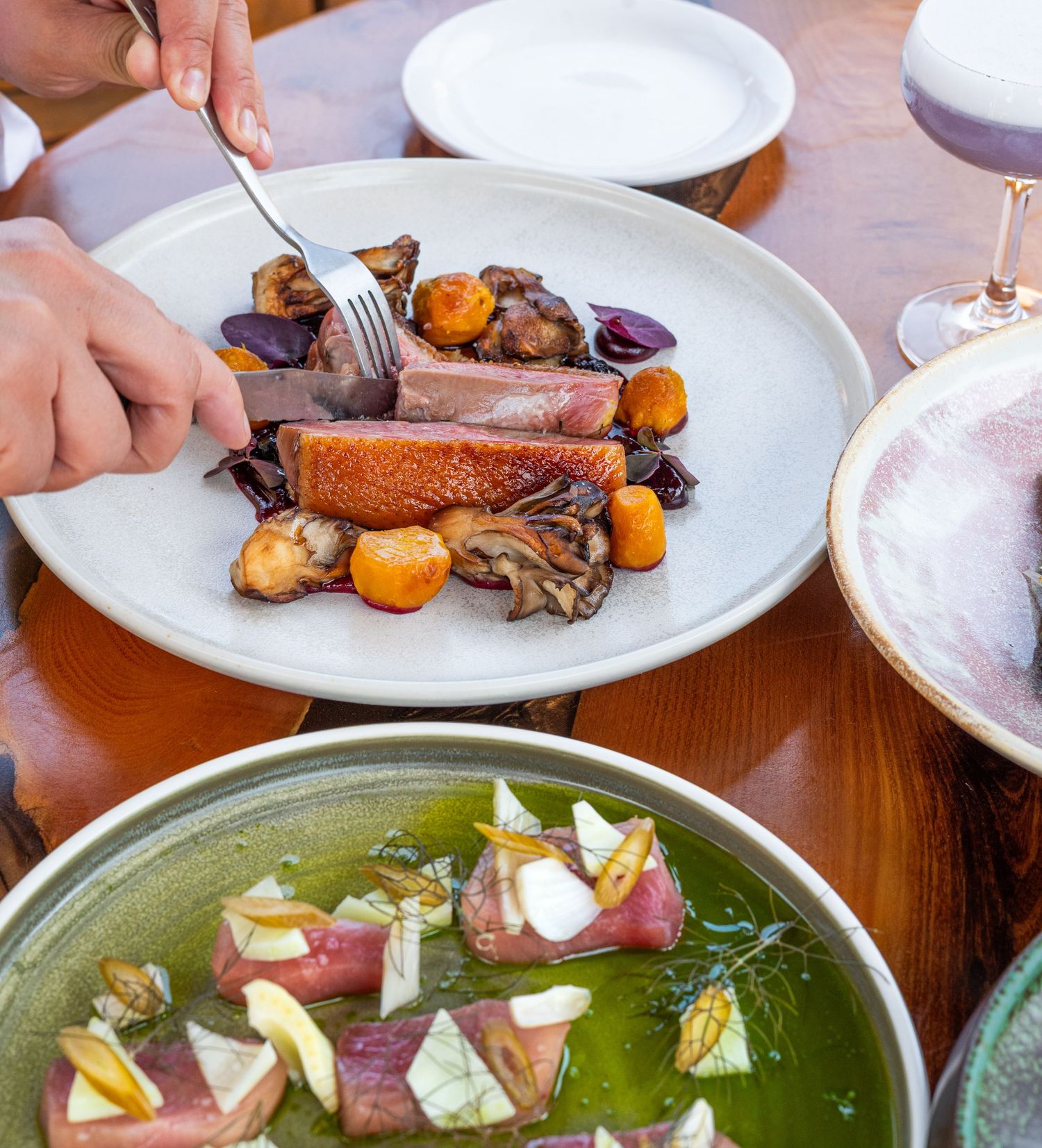 person cutting into a dish