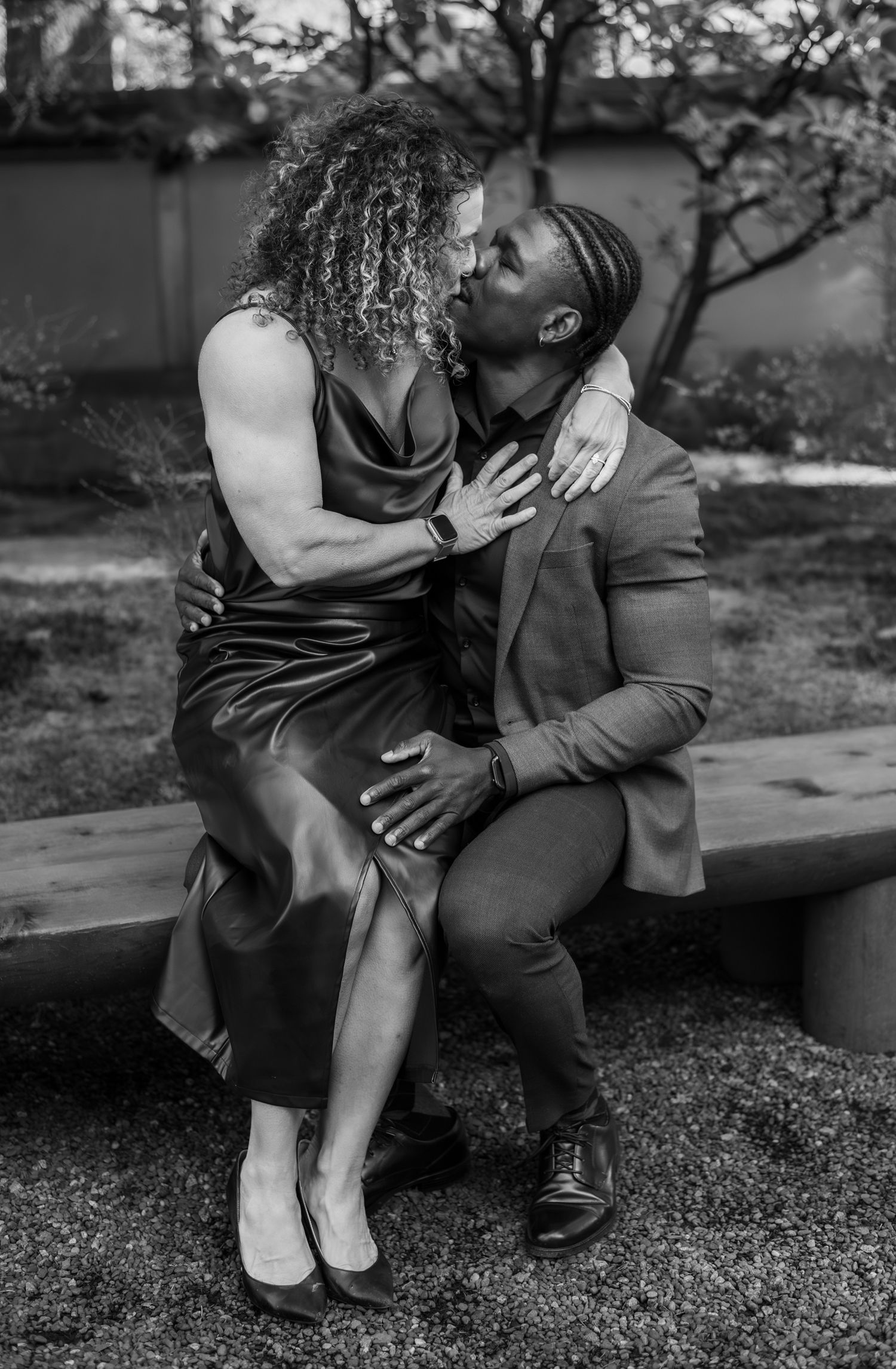 woman sitting on mans lap kissing him