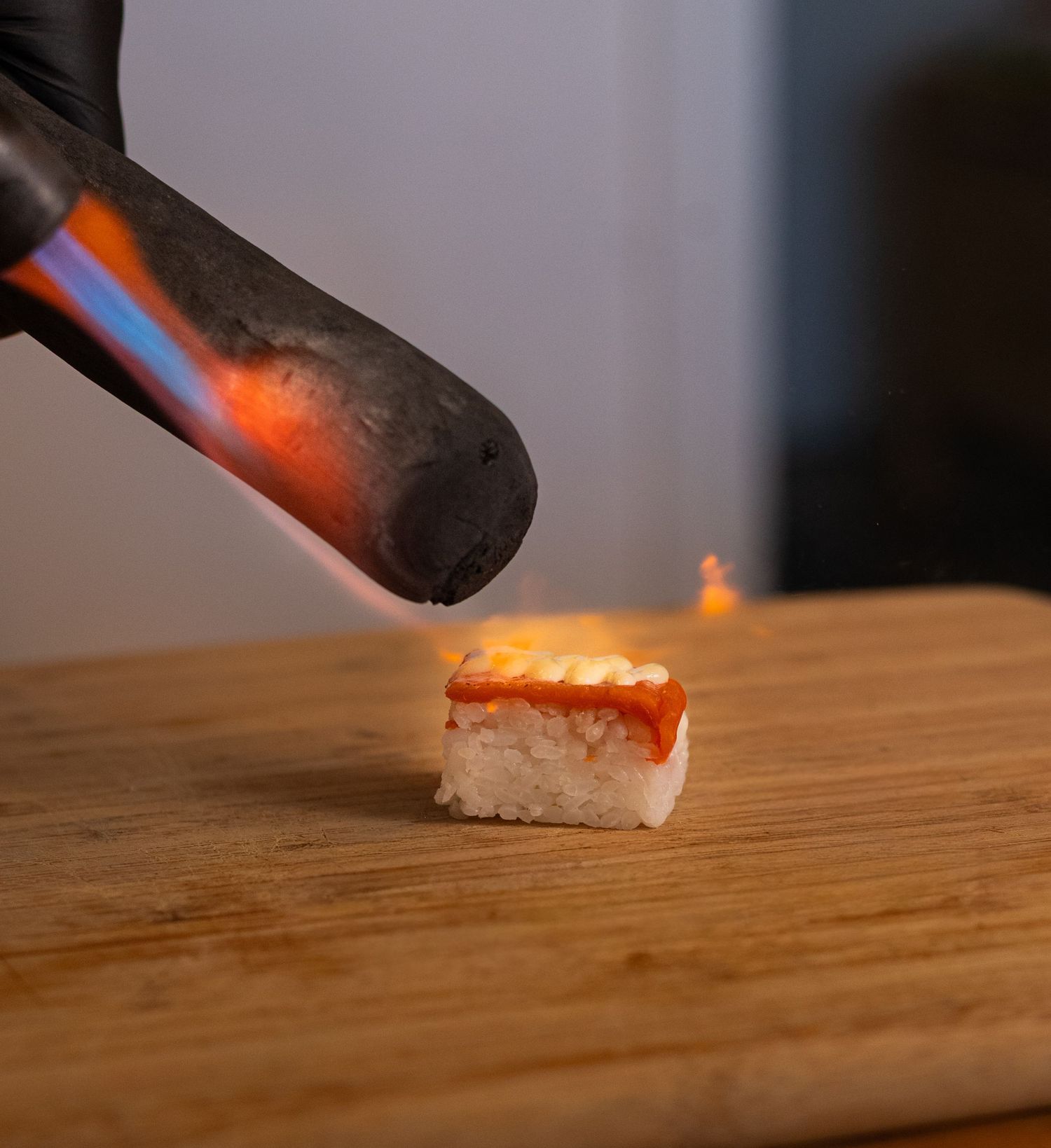 piece of sushi being flamed