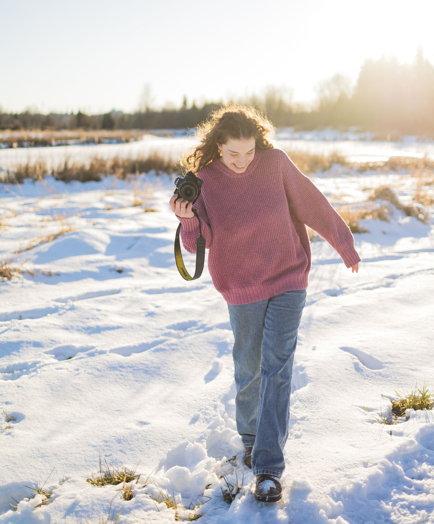 a woman with her camera in the snow