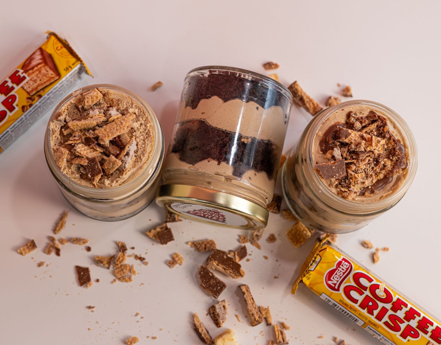 a photo of cake jars with crumbles and coffee crisp bars
