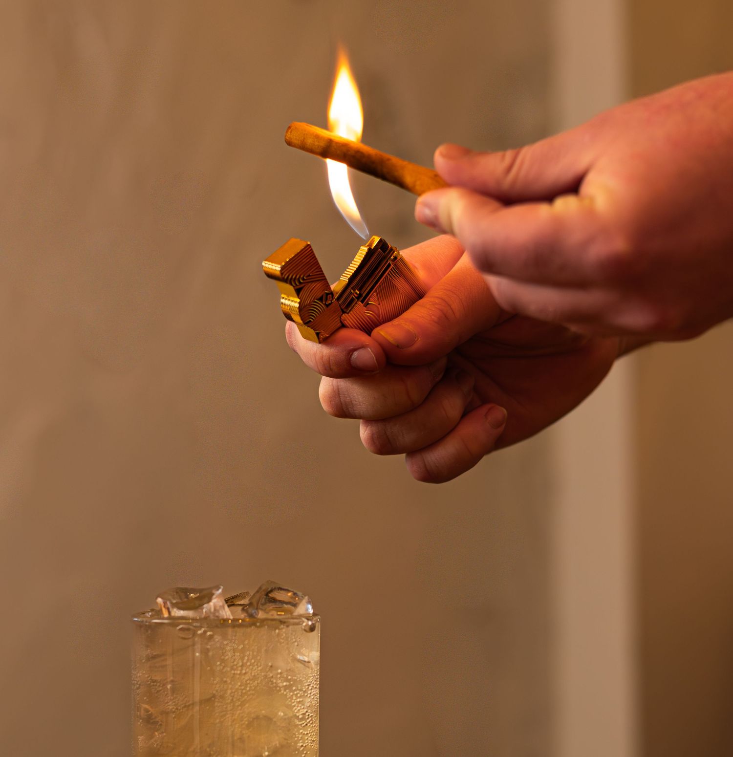 cinnamon stick being lit on fire for a drink