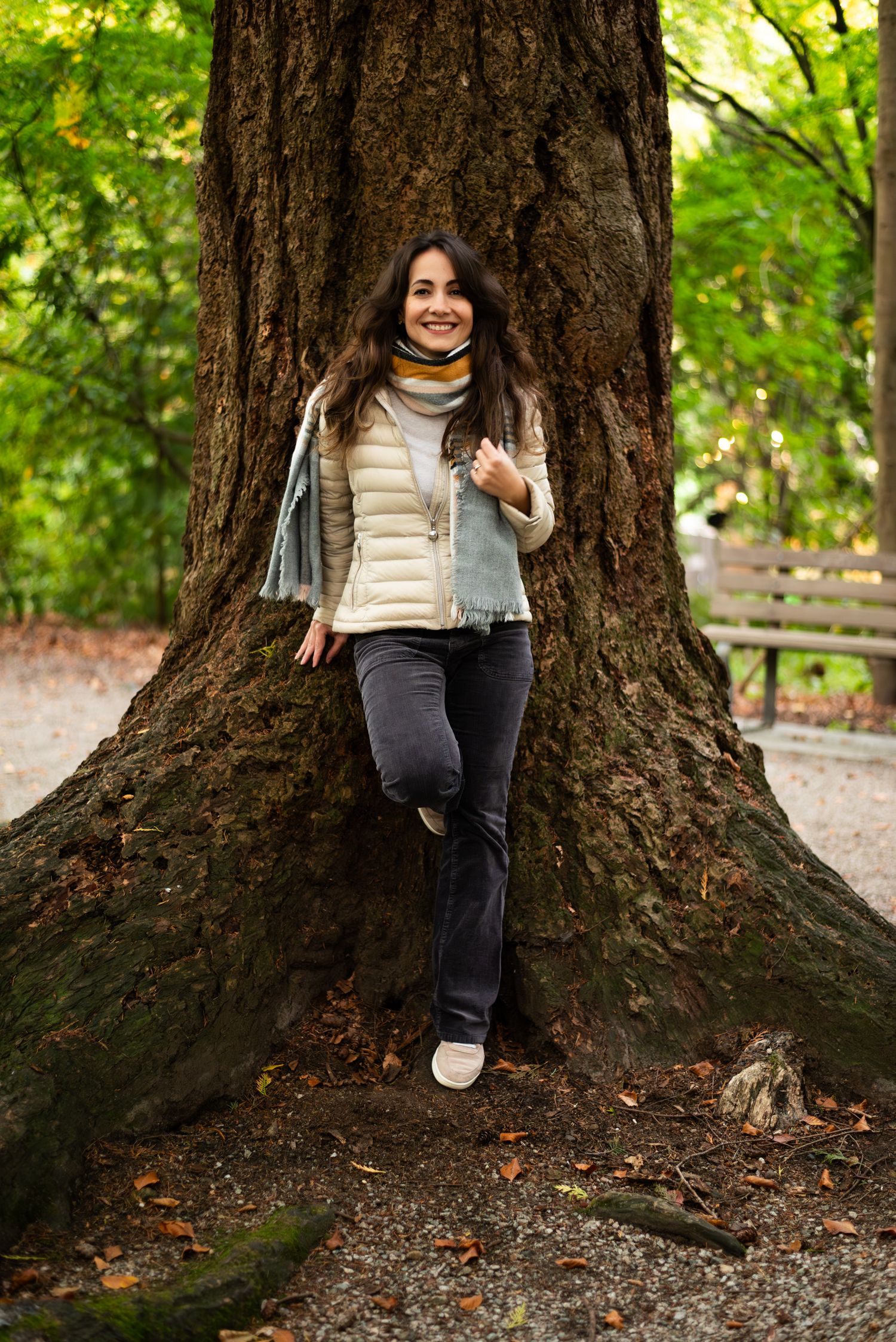 woman posing against a tree