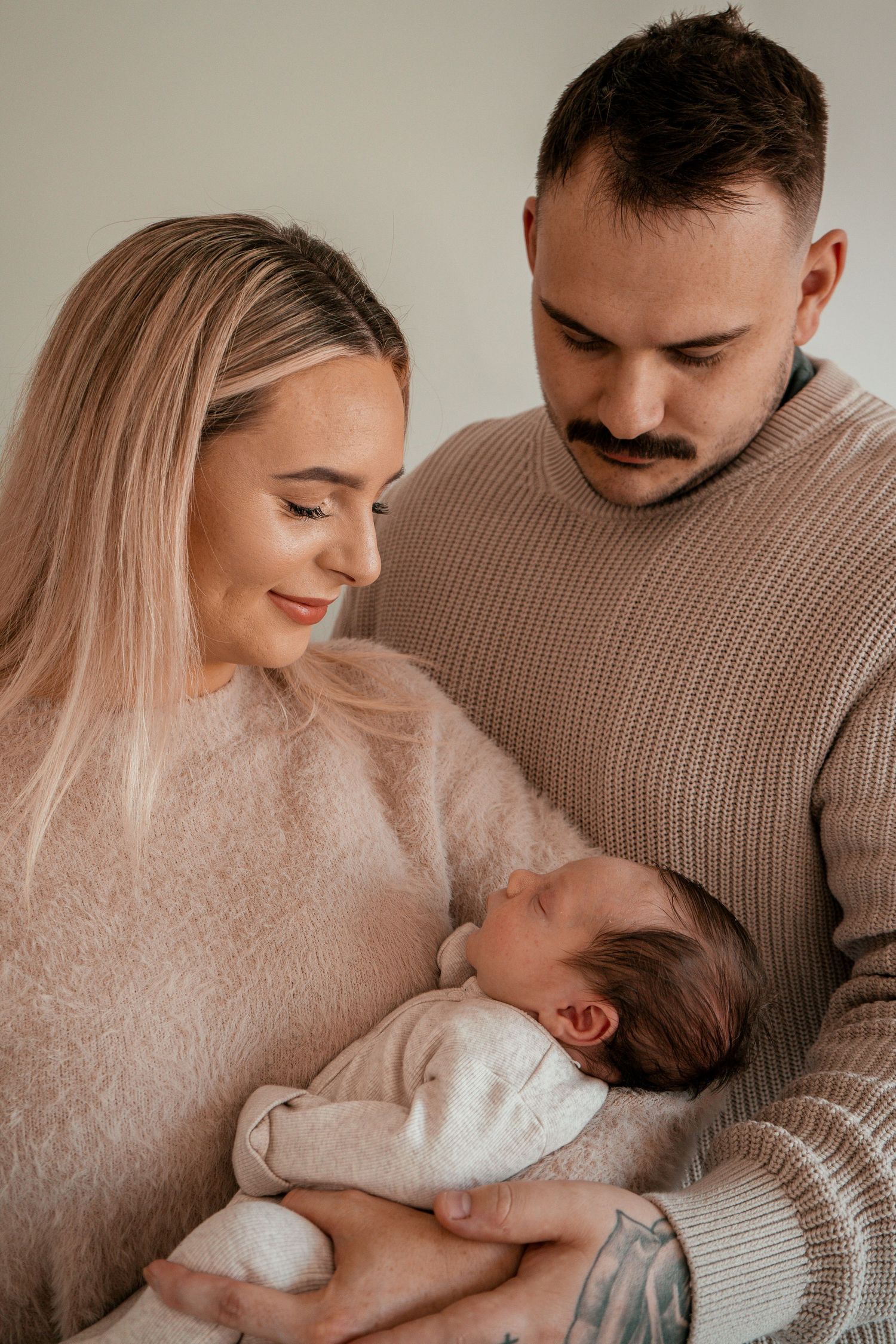 A heartwarming sequence of a family sharing gentle moments together in muted beige tones.