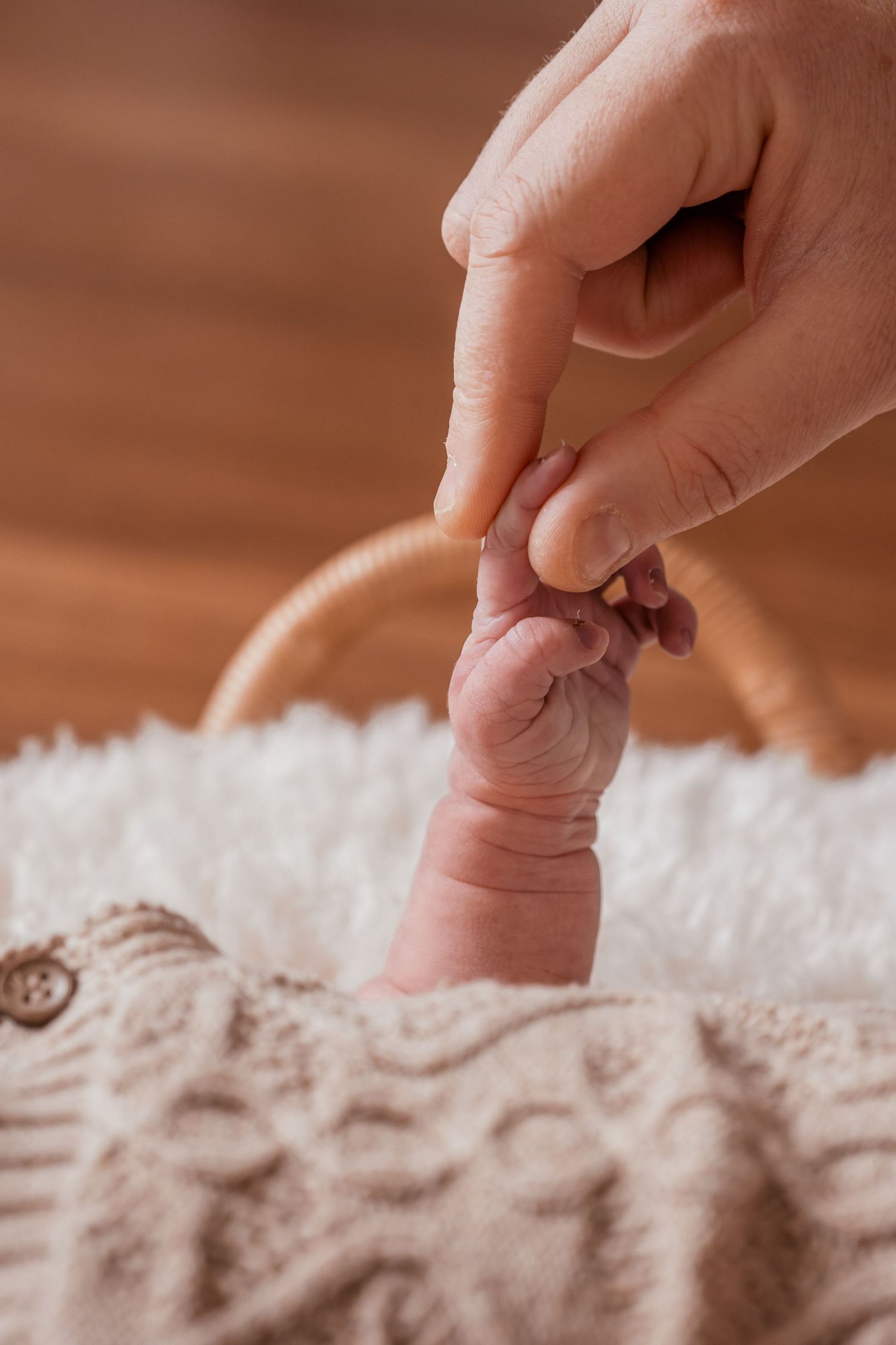 A finger presses into soft white carpet fibers creating indentations on the plush surface.