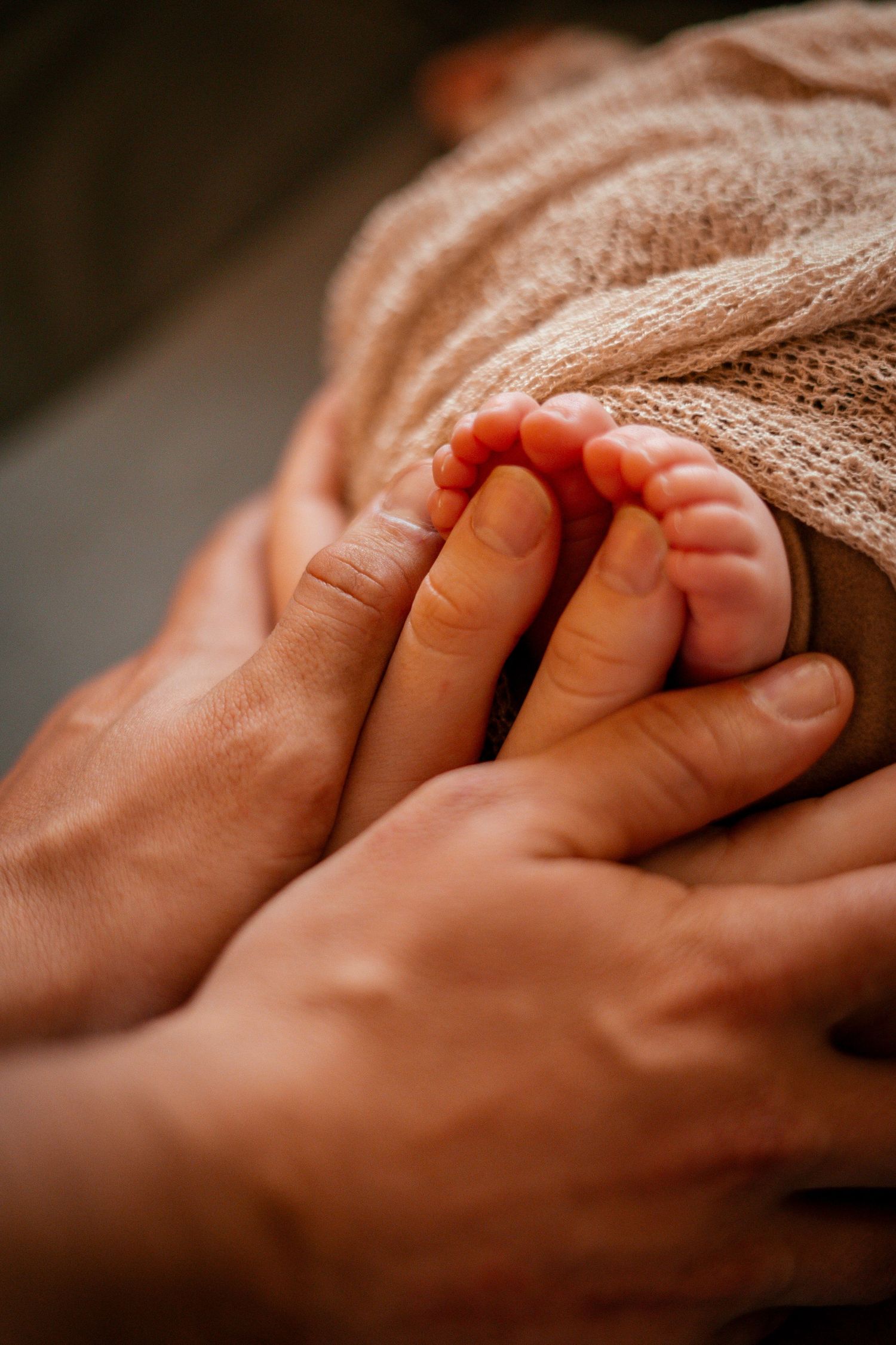 A close-up sequence showing two hands gently clasping and intertwining in a warm, intimate gesture.