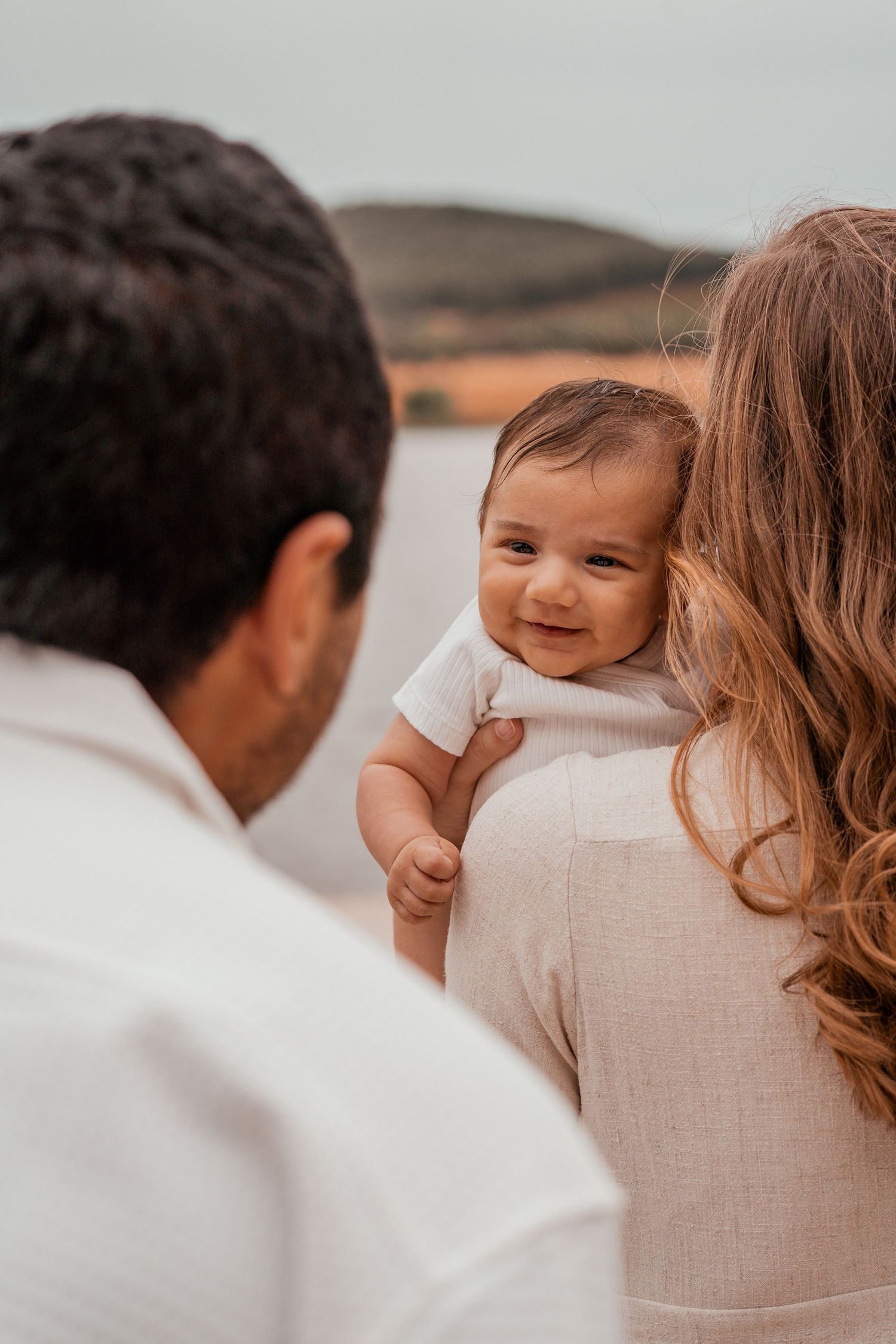 A heartwarming family moment captured in a series of candid photos against a soft neutral background.