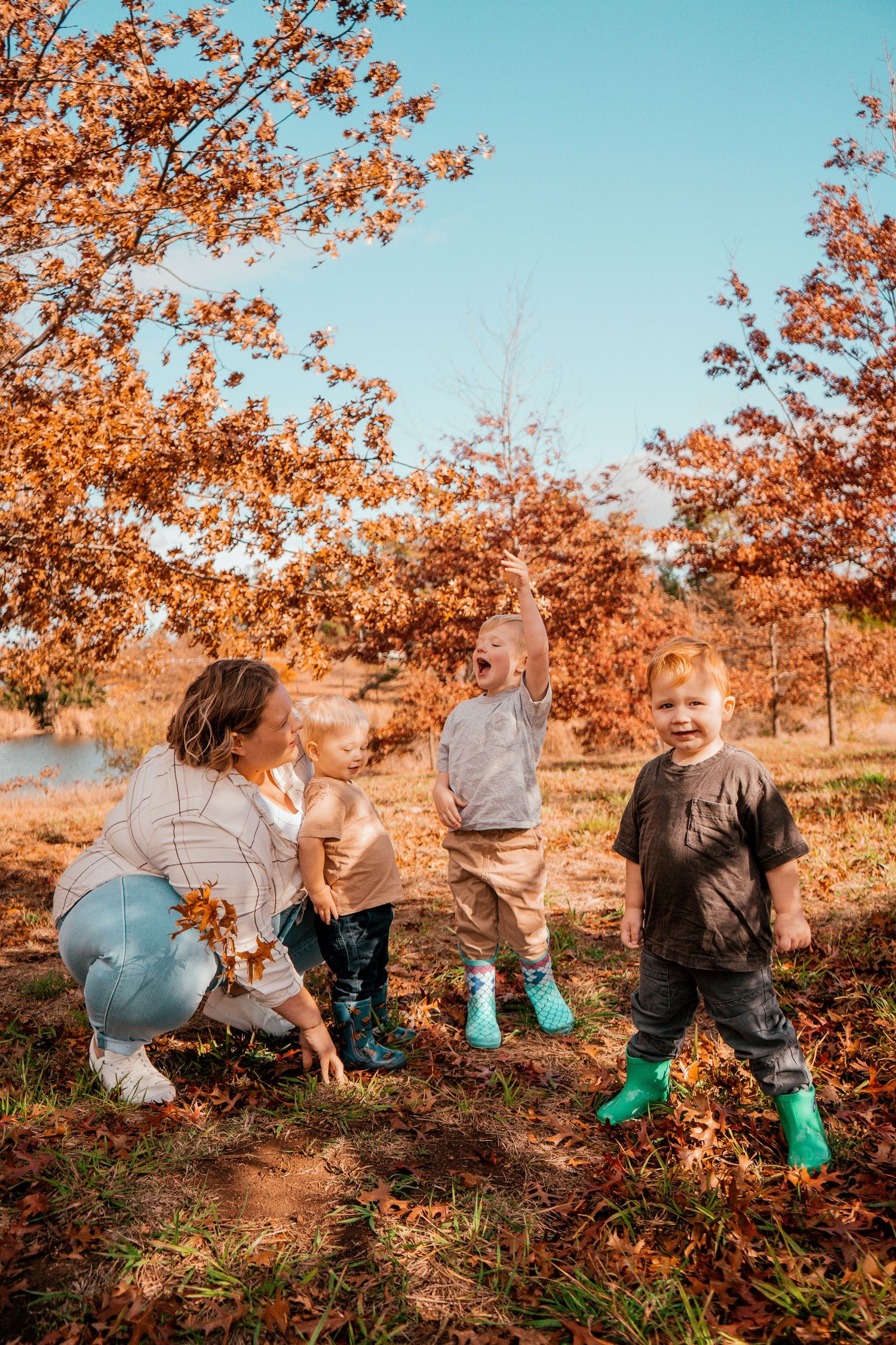 Sequential photos showing someone in blue rubber boots picking pumpkins in an autumn field under golden leaves.