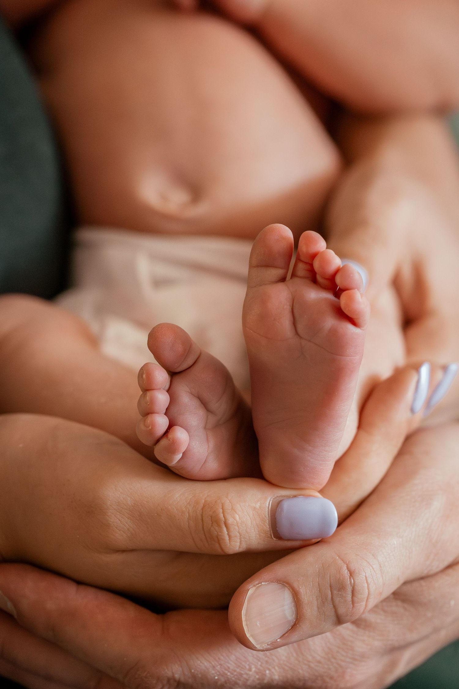 Close-up series of tiny baby feet being gently held by adult hands showing different angles and details.