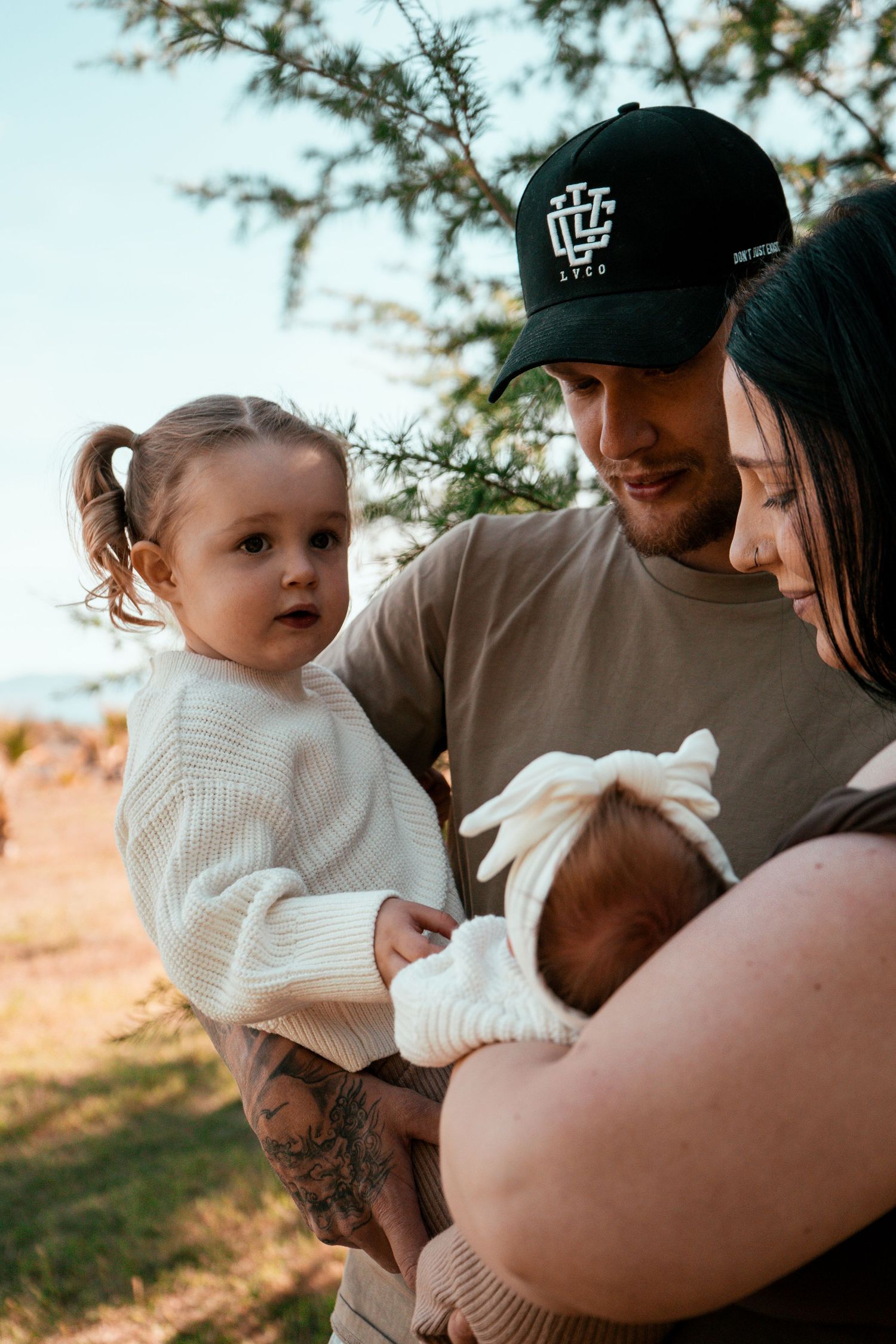 Outdoor family moment captured against natural backdrop in warm lighting.