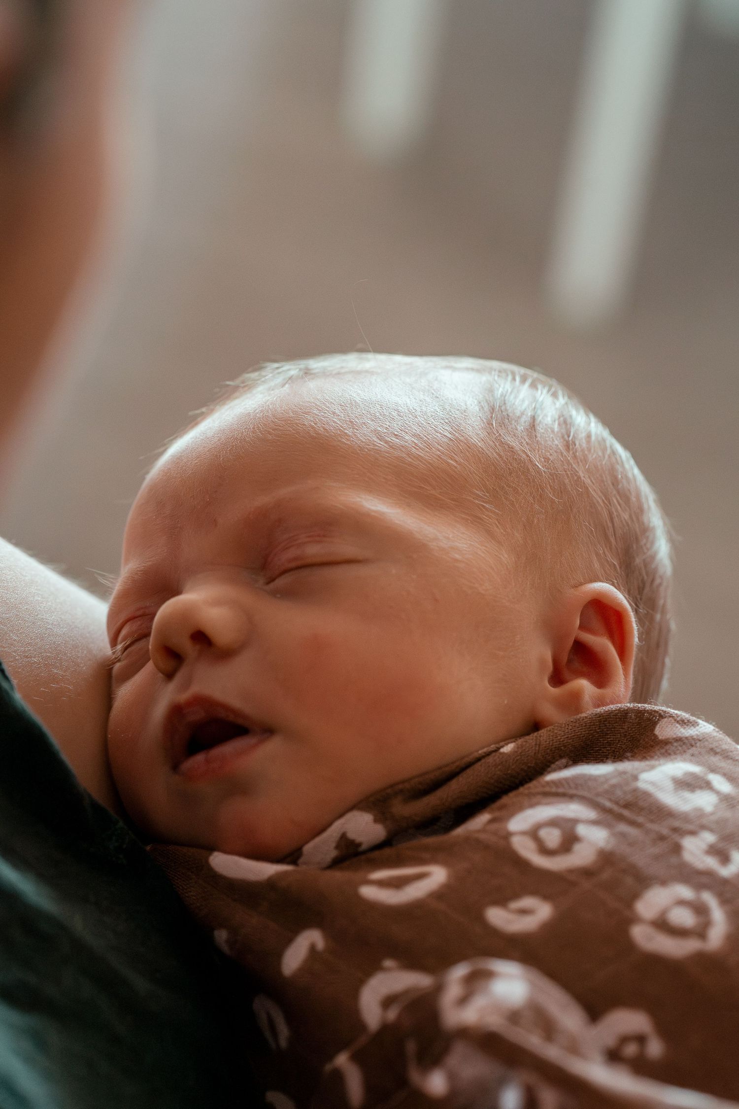 Series of peaceful sleeping newborn images in brown clothing showing different angles of rest.