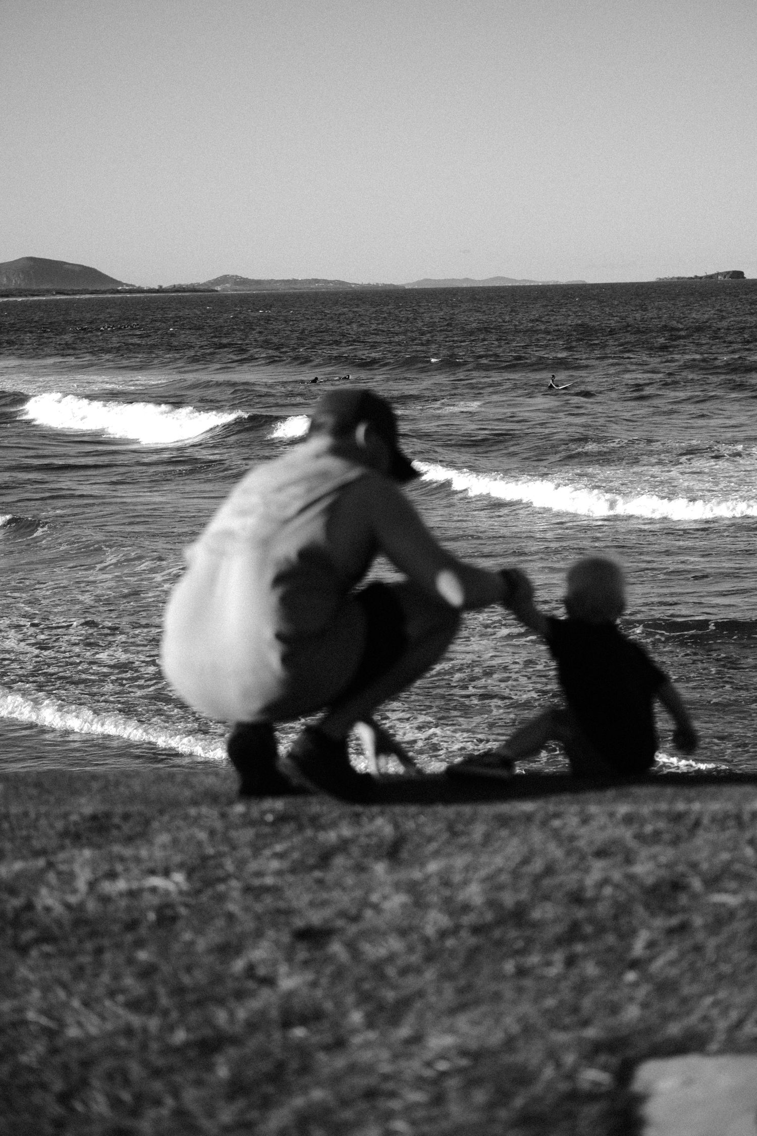 father and sun, perfect blend of natural light, Candid street photography capturing a raw and authentic urban moment, family, black & white