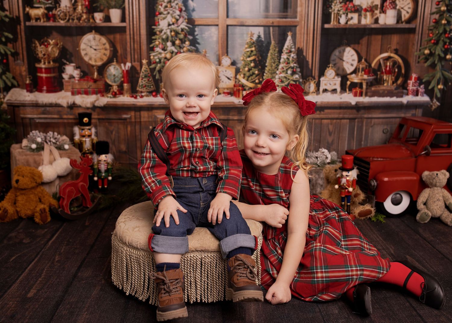Children in plaid holiday outfits pose for festive Christmas photos with rustic wooden backdrop and decorations.