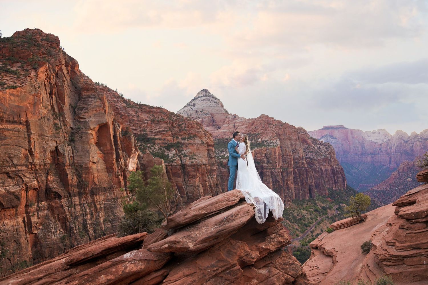 Panoramic views of red rock formations and scenic hiking trails at Zion National Park during golden sunset hour.
