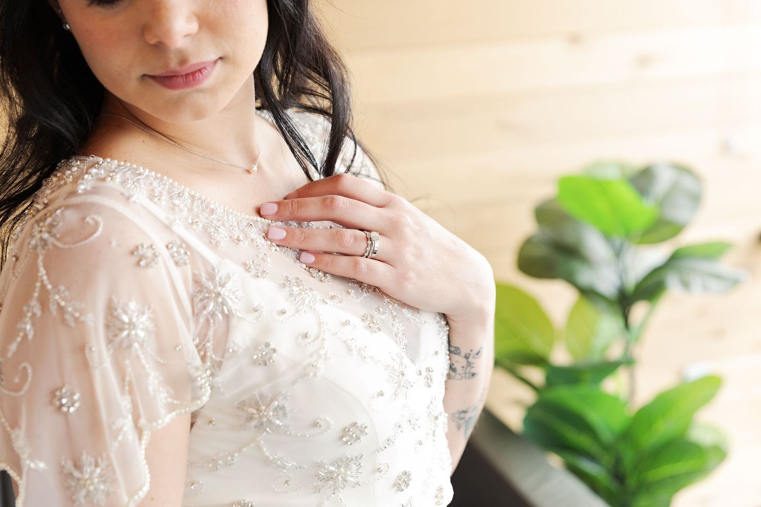 Detail of intricate lace wedding dress with floral embellishments.