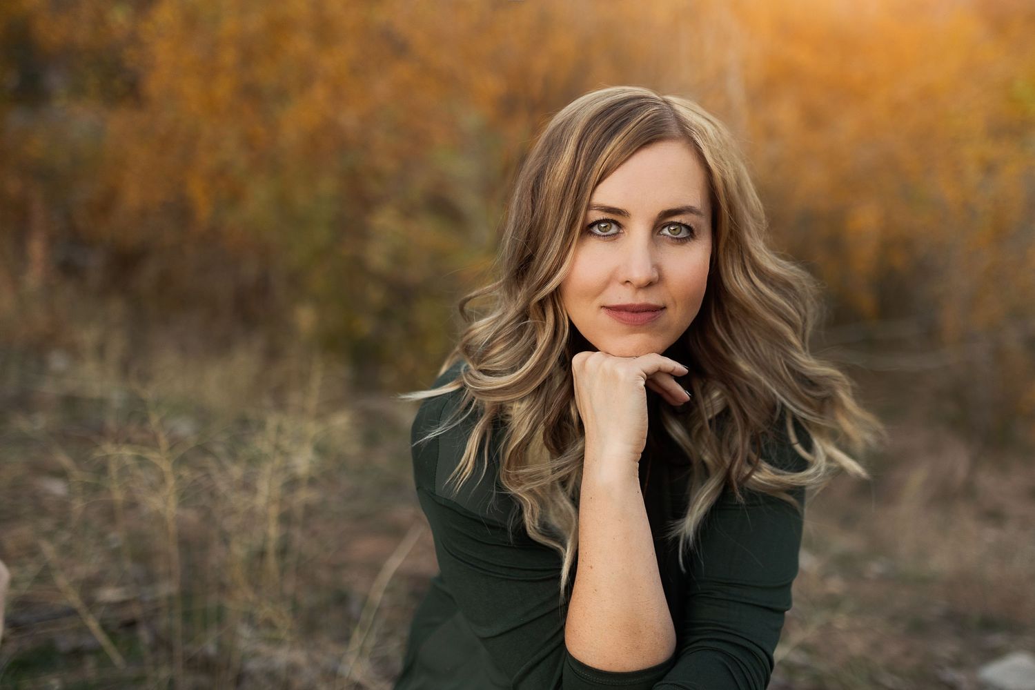 Outdoor autumn portrait with warm golden lighting and natural background.