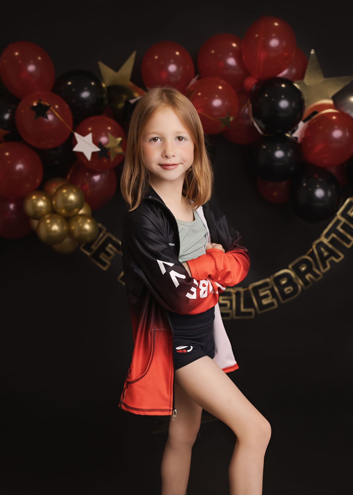 A photographed sequence shows a young athlete striking a cheerleading pose against a festive red, gold and black balloon backdrop.