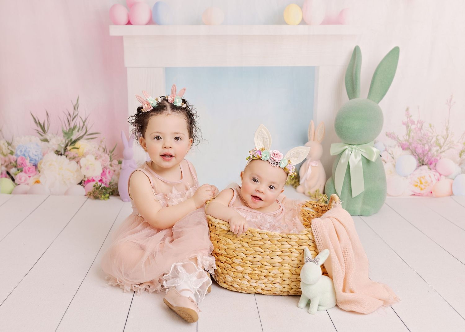 A series of Easter-themed baby portraits with pastel decorations, bunny props, and floral backdrops.
