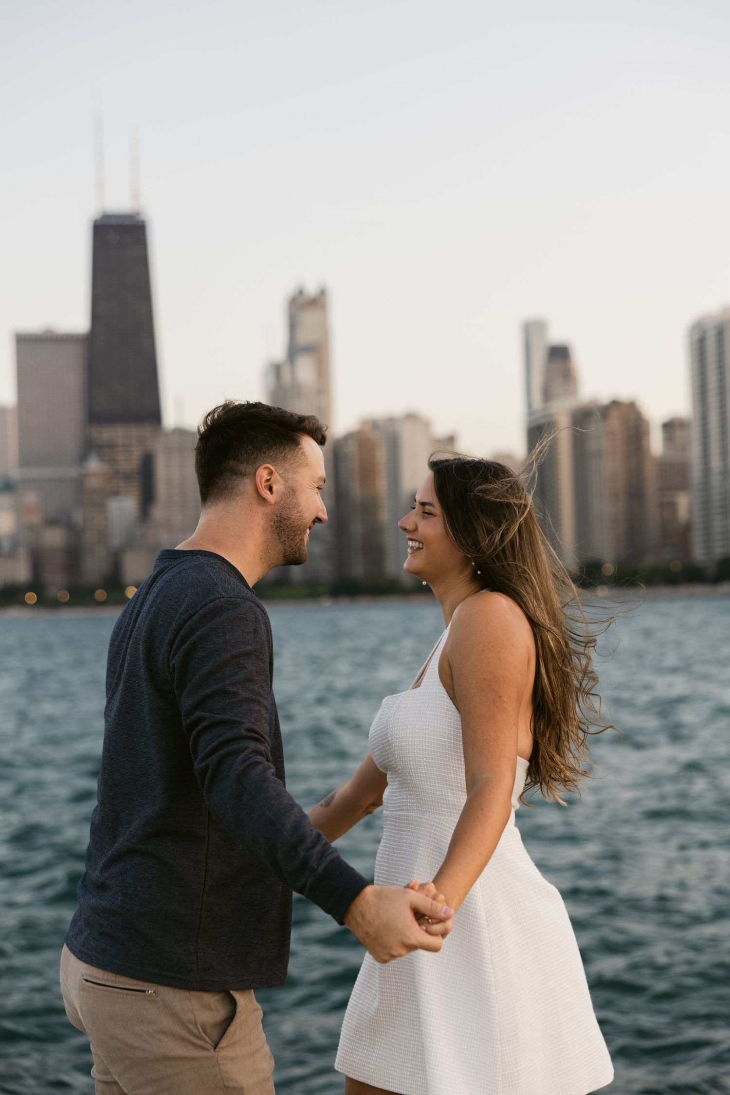 A romantic moment captured against Chicago's stunning waterfront skyline at dusk.