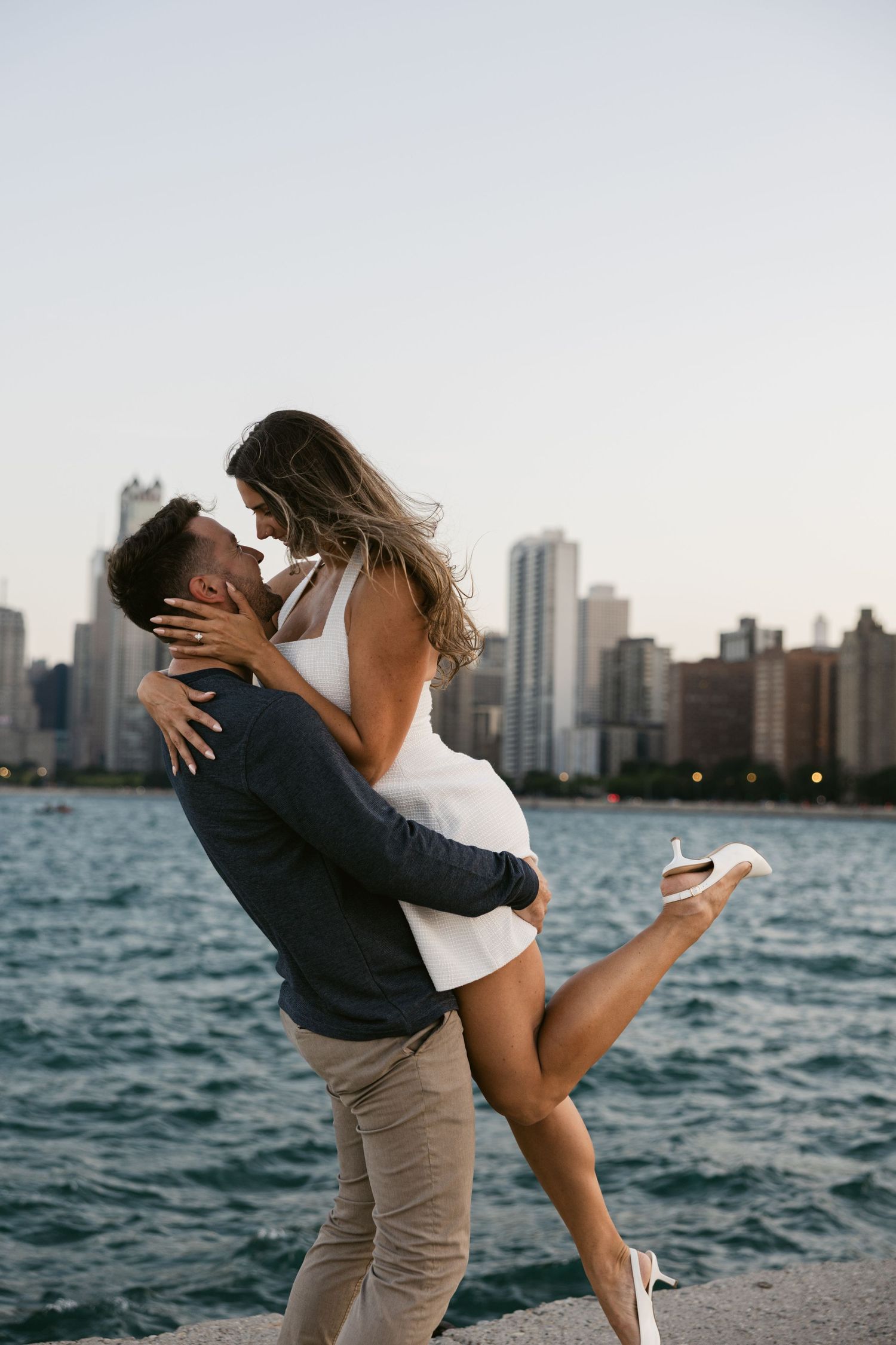 Playful moment captured against Chicago's majestic waterfront skyline at dusk.