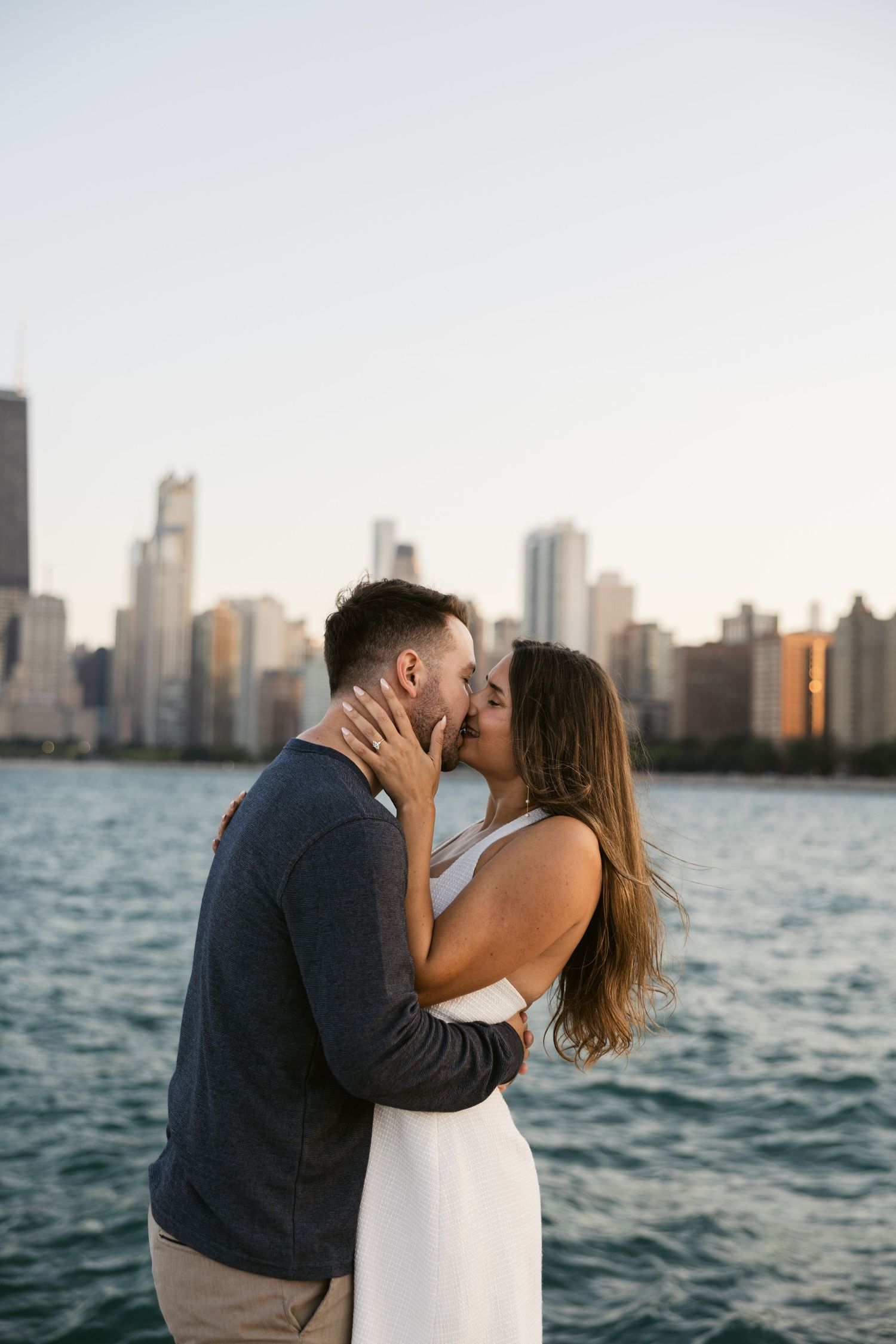 A romantic moment at sunset with the Chicago skyline visible across Lake Michigan.